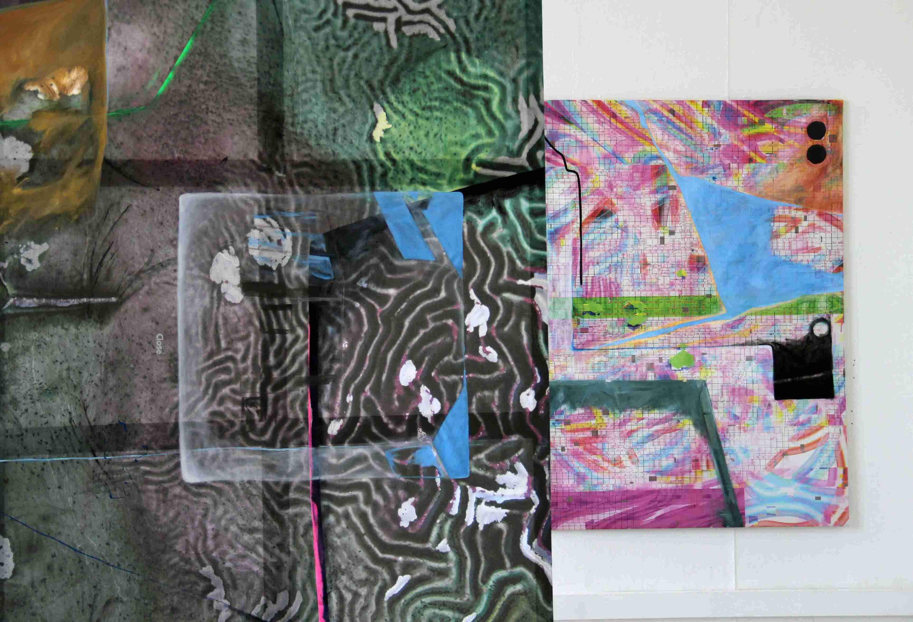 Two brightly coloured paintings, one hanging in the foreground, one against the wall in the background