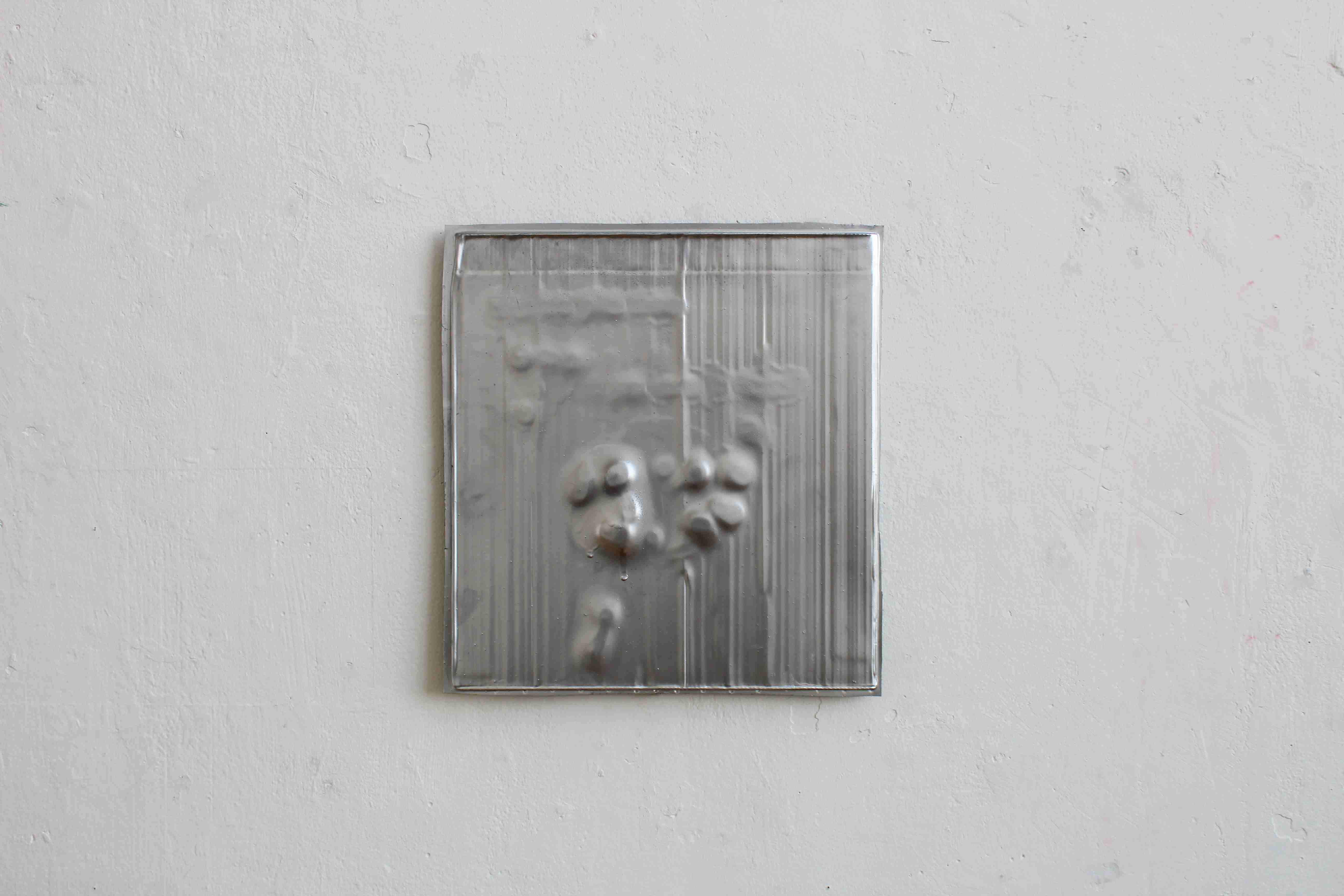 Silver metal painting on white wall