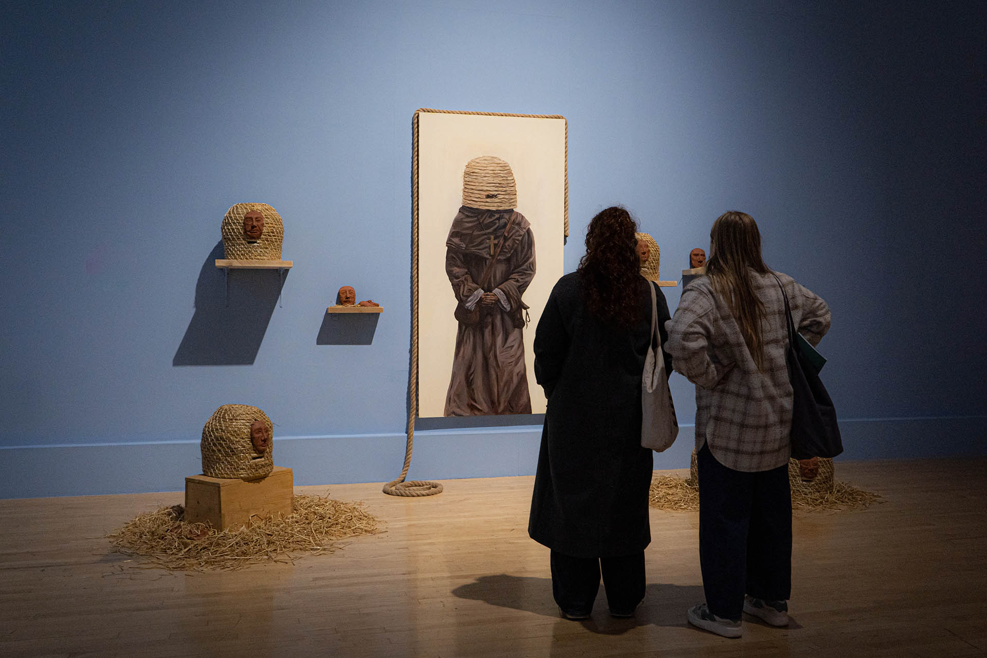 Two people stood in front of installation. 