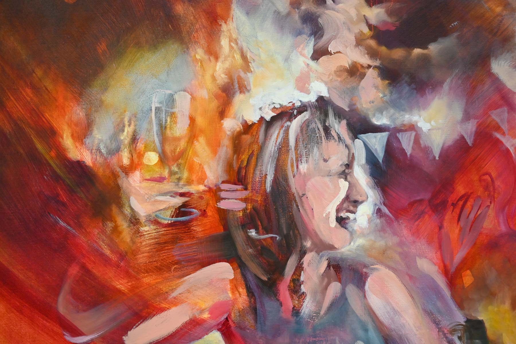 Close up, woman holds a champagne glass surrounded by flames