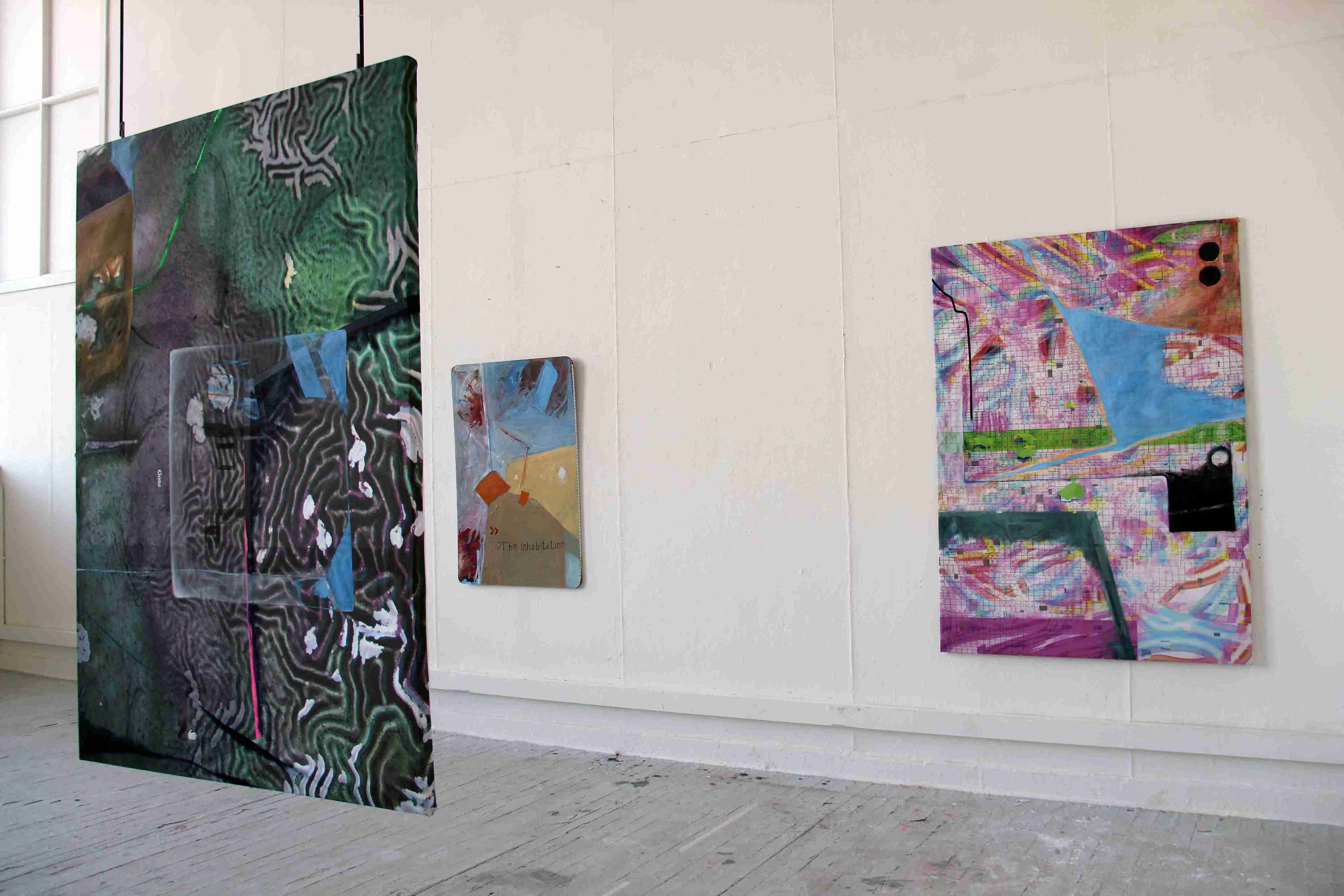 3 paintings hanging in a room