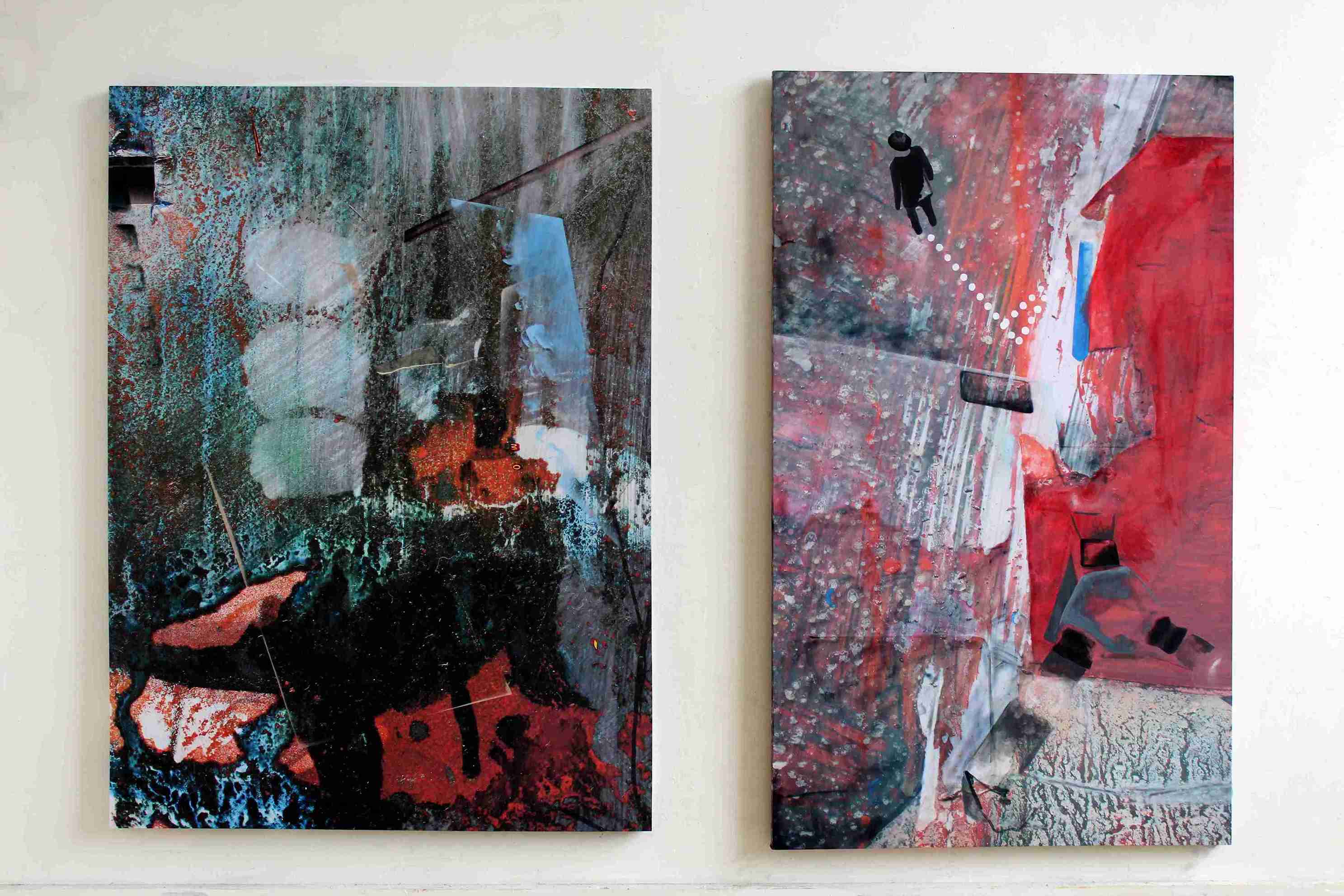 Two large dark architectural printed paintings on a wall