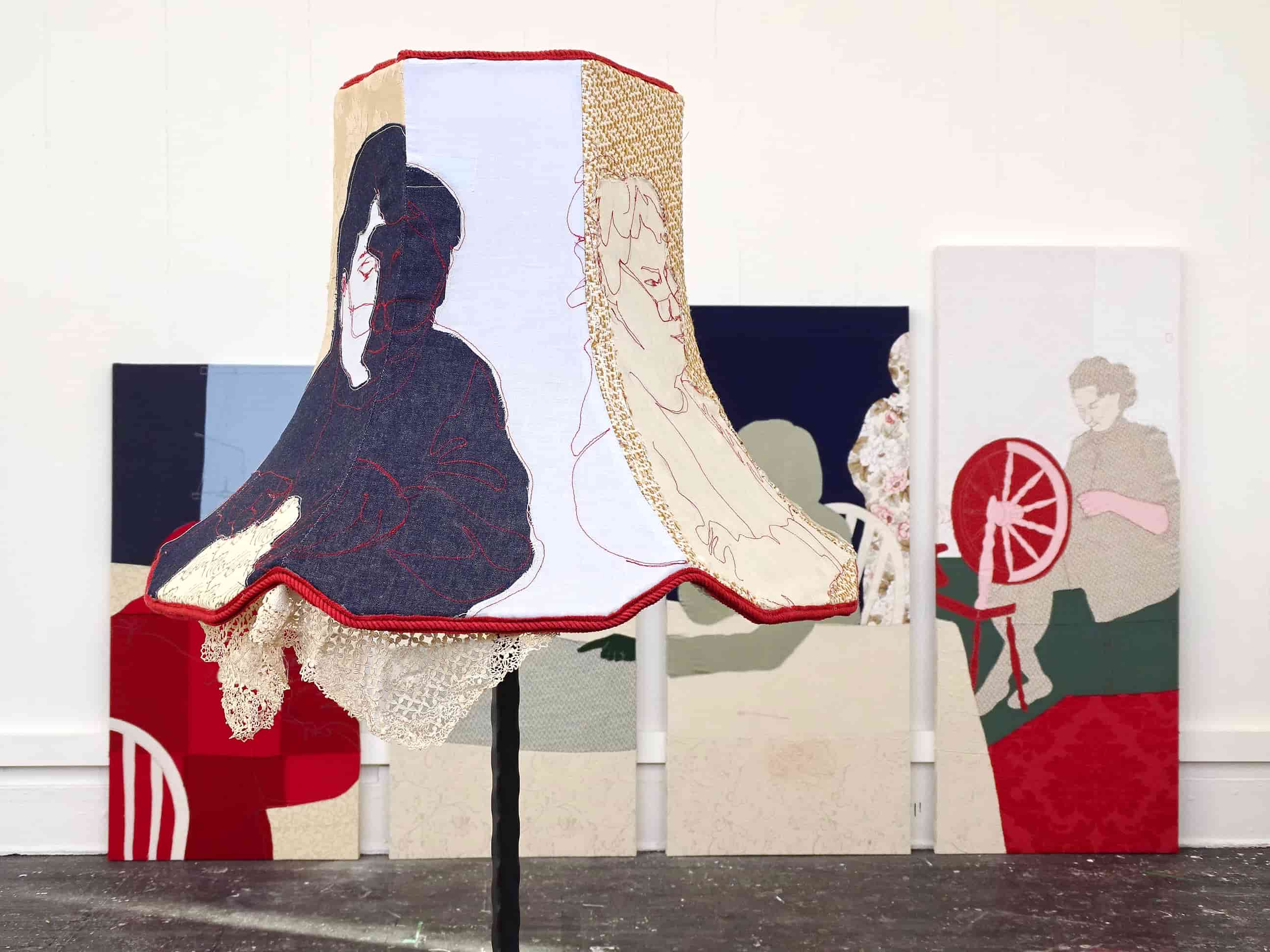 Upholstered Lamp ‘Maria’ in front of fabric stretched frames ‘Labour of Love’