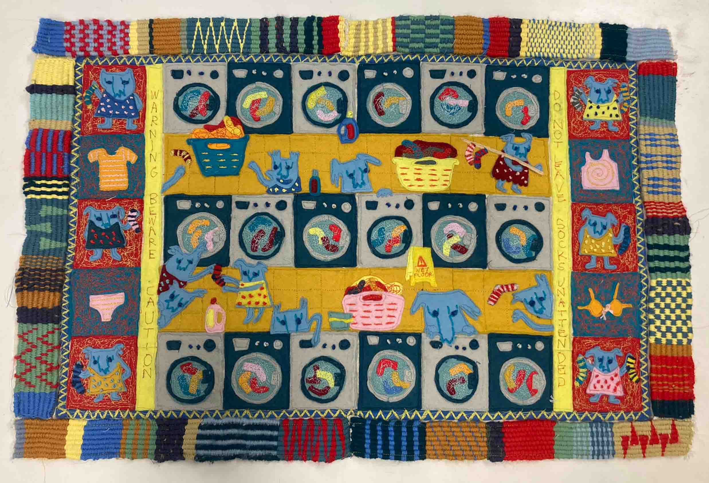 felt applique hanging showing monsters stealing socks from washing machines