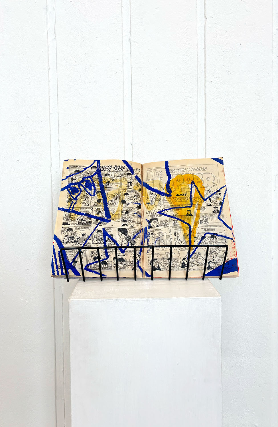 comic book on a stand with comic stars screen printed on top 