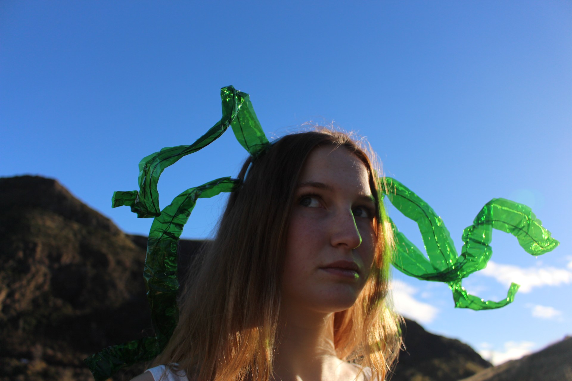 Image of Lucy with green forms emerging from her head.
