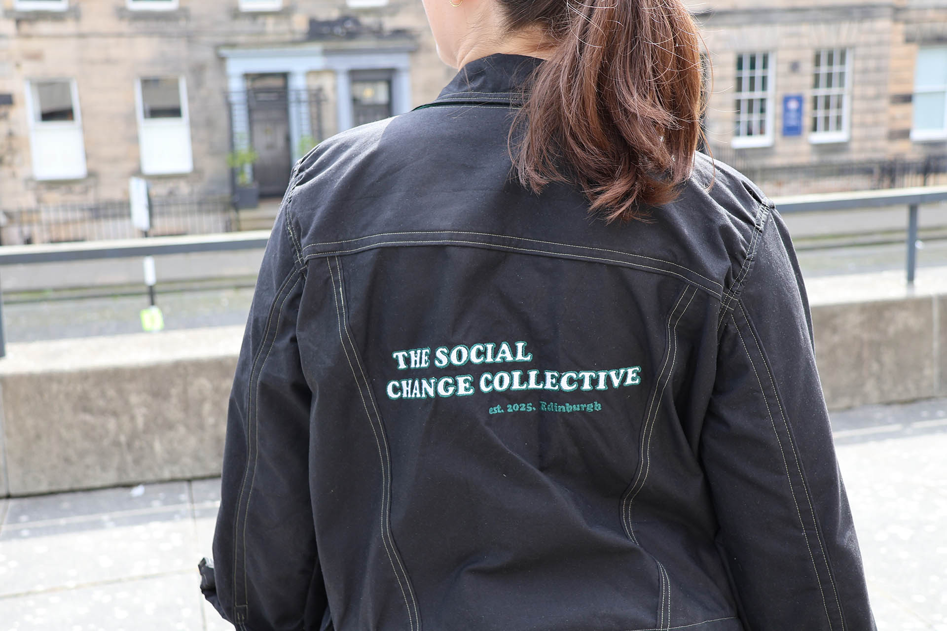 Back logo of The Social Change Collective jacket