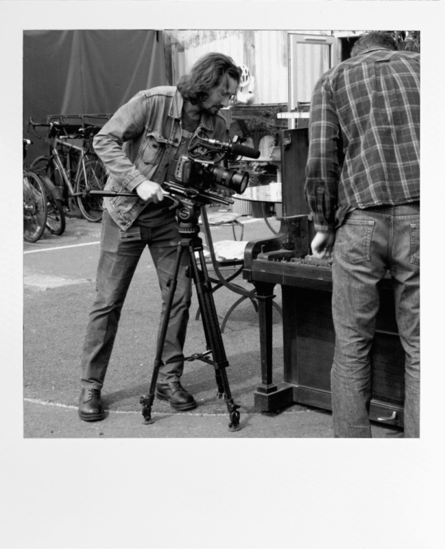 A polaroid of a Person at a Movie Camera
