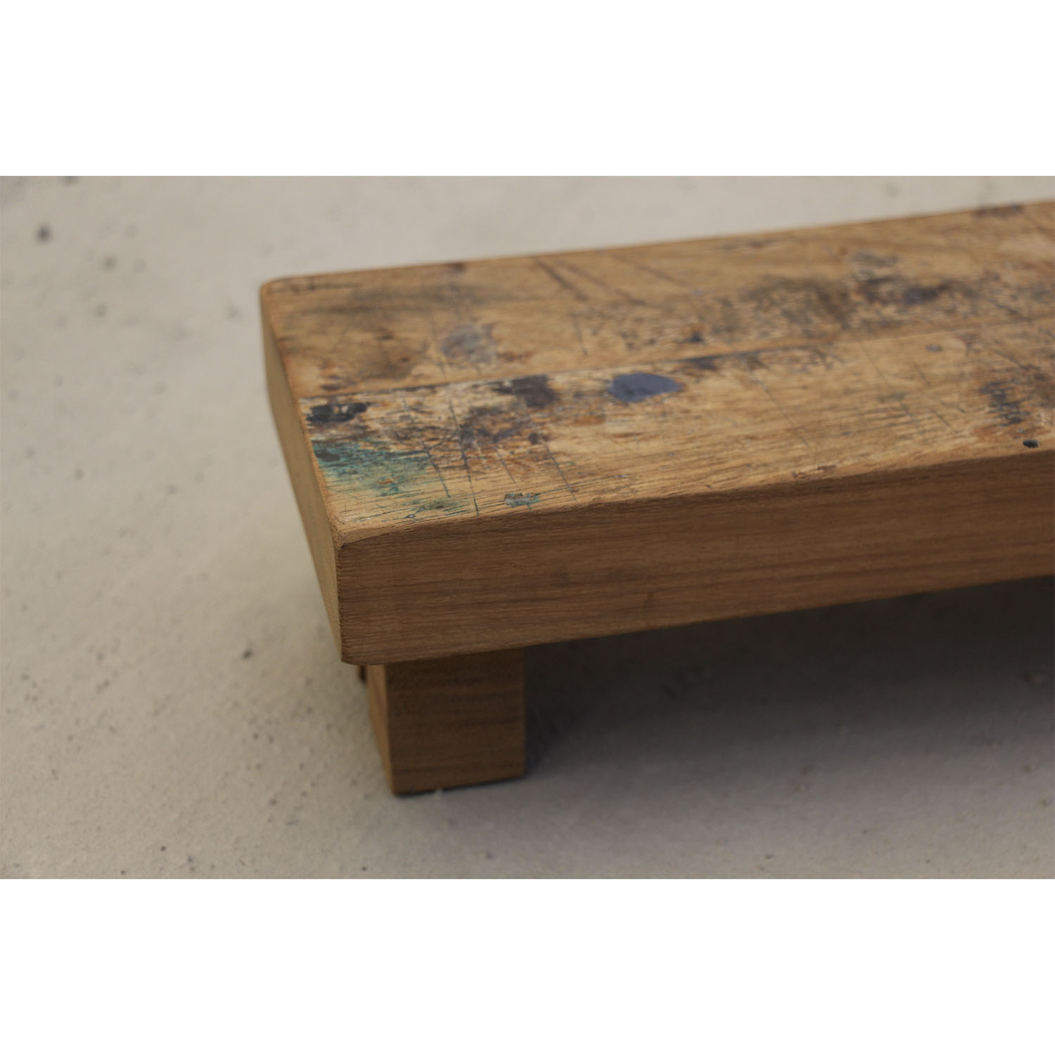     Close-up photograph of a teak wooden stool