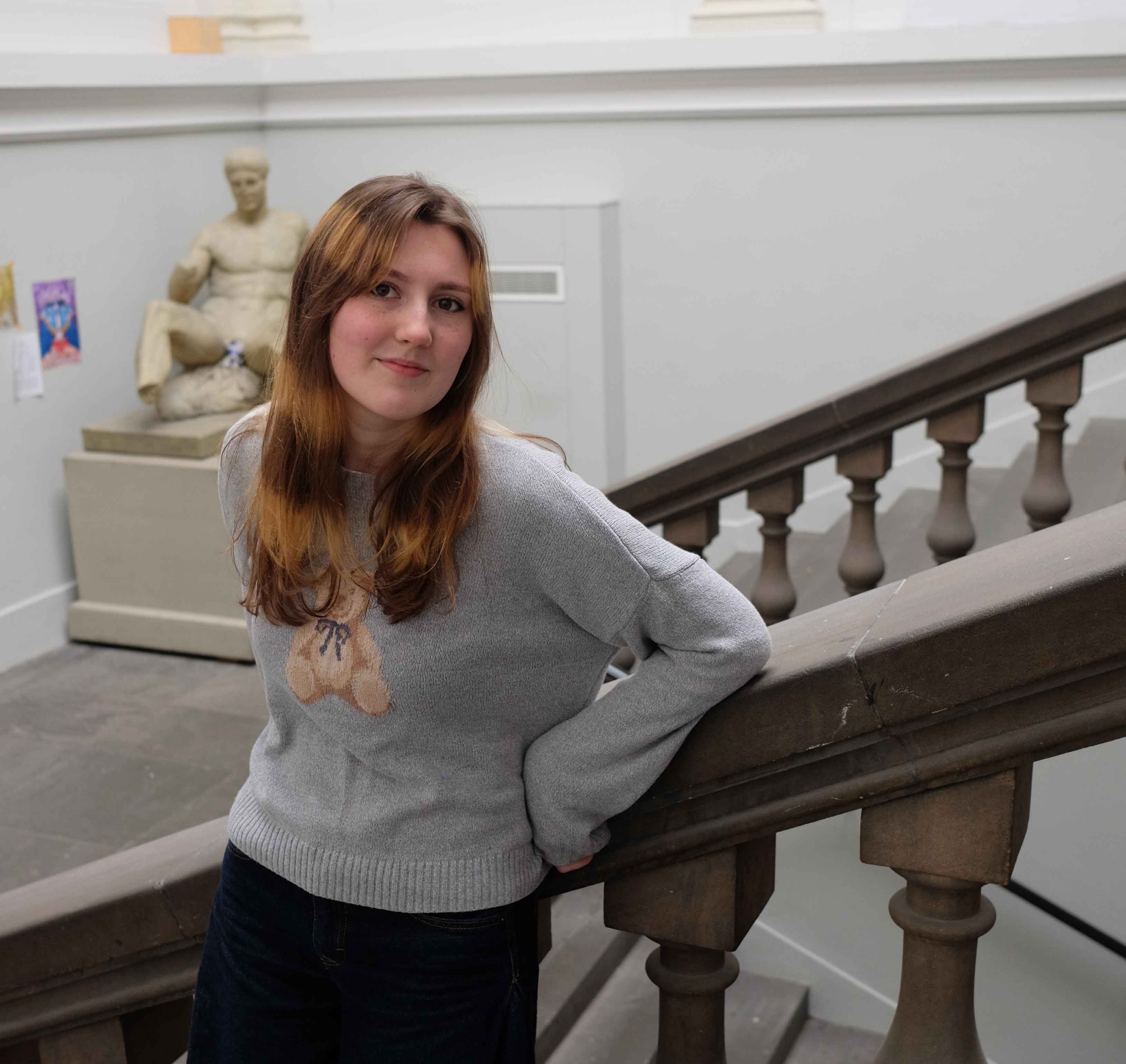 Artist with stripy hair on the staircase of the ECA Main Building.