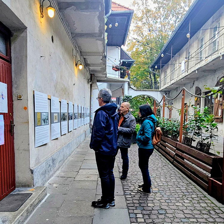Tutors of the Memory and Forgetting Studio reading the memorial panels at 7 Józefa Street, Kazimierz district, Kraków, (known as the Schindler's List Passage), used in the filming of the 1993 film Schindler's List. 