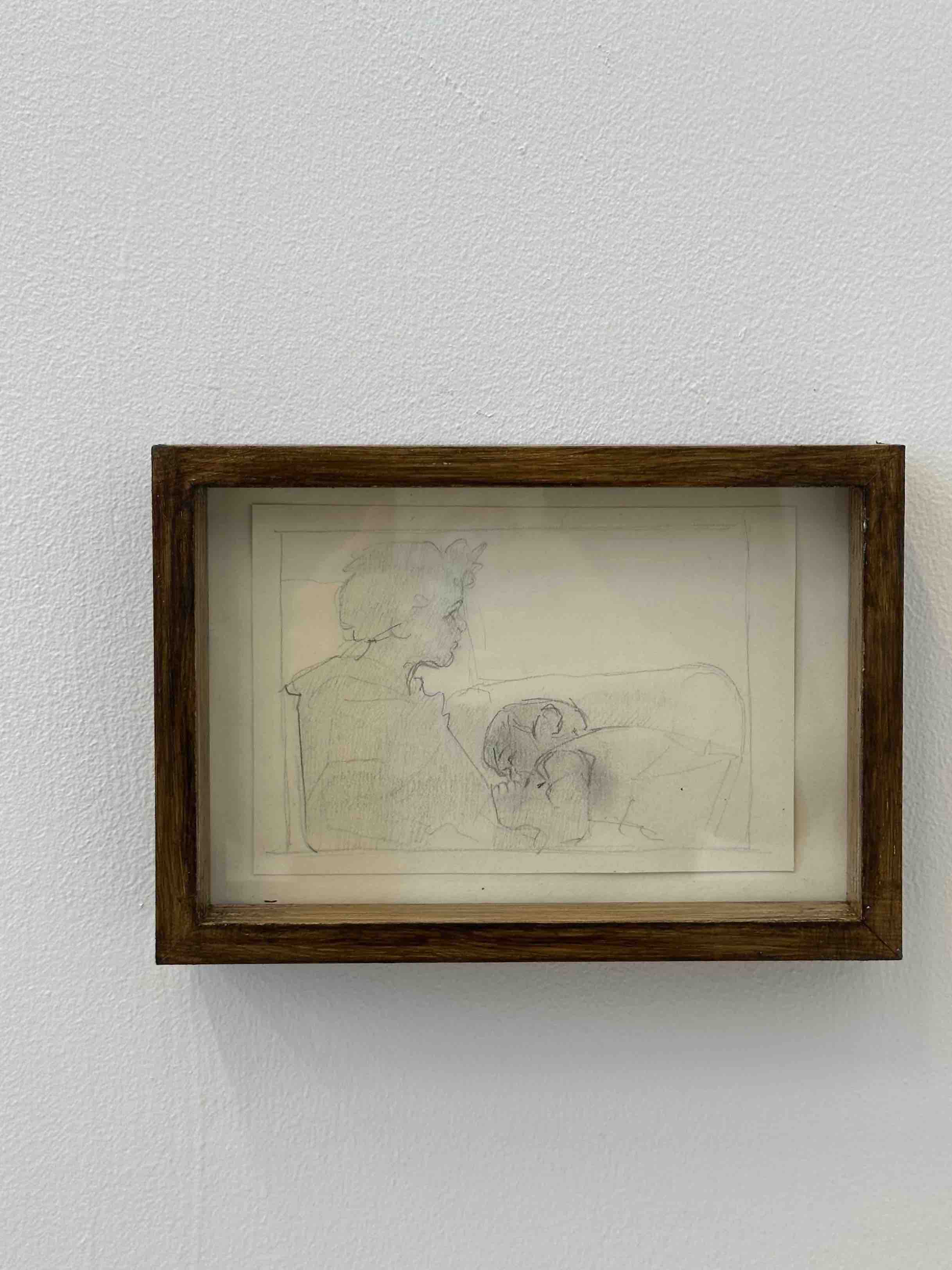Framed picture of two children. The younger one lies curled up against the older girl.