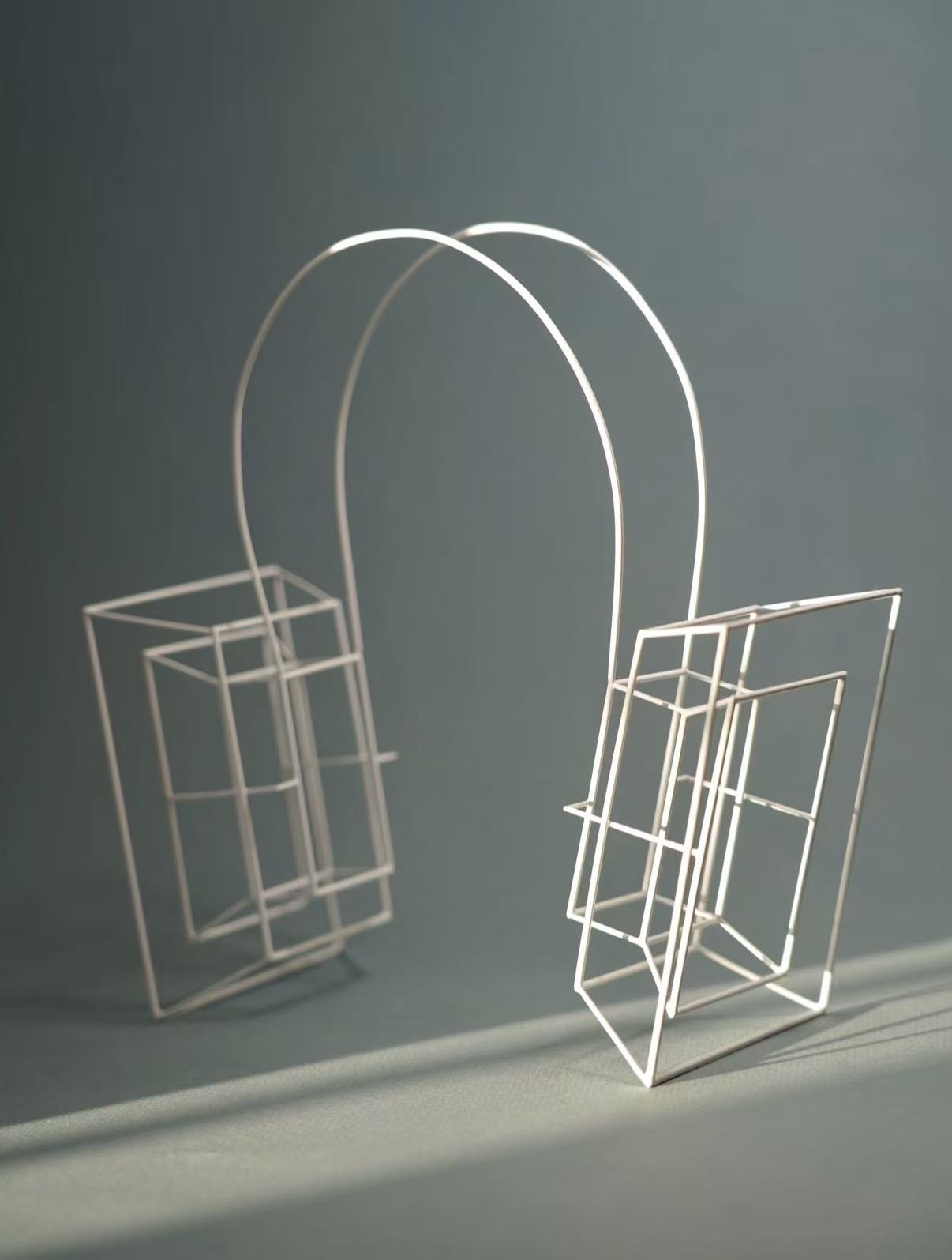 Exploring the feeling of being constrained by external voices and social expectations, this piece uses structured forms surrounding the ear to represent discipline, control, and restriction.