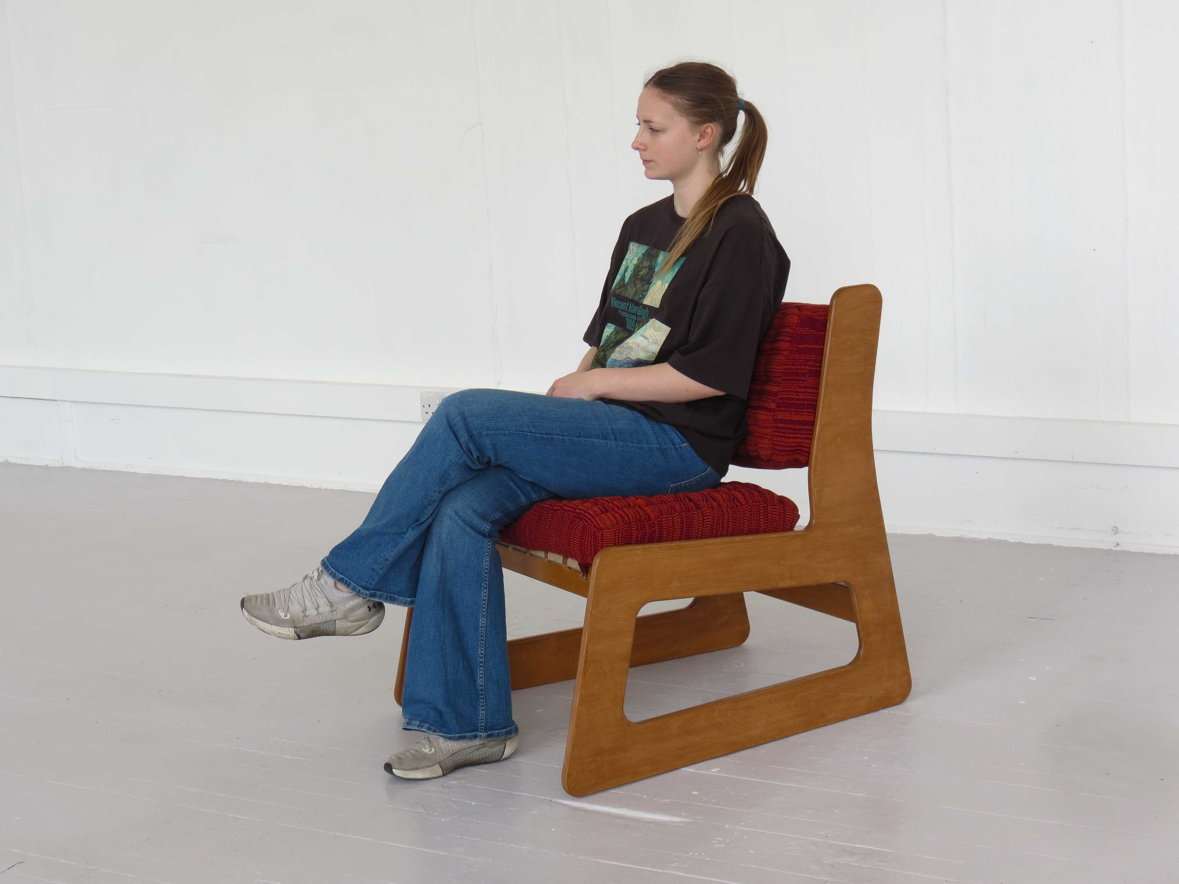 Woman sitting on chair.