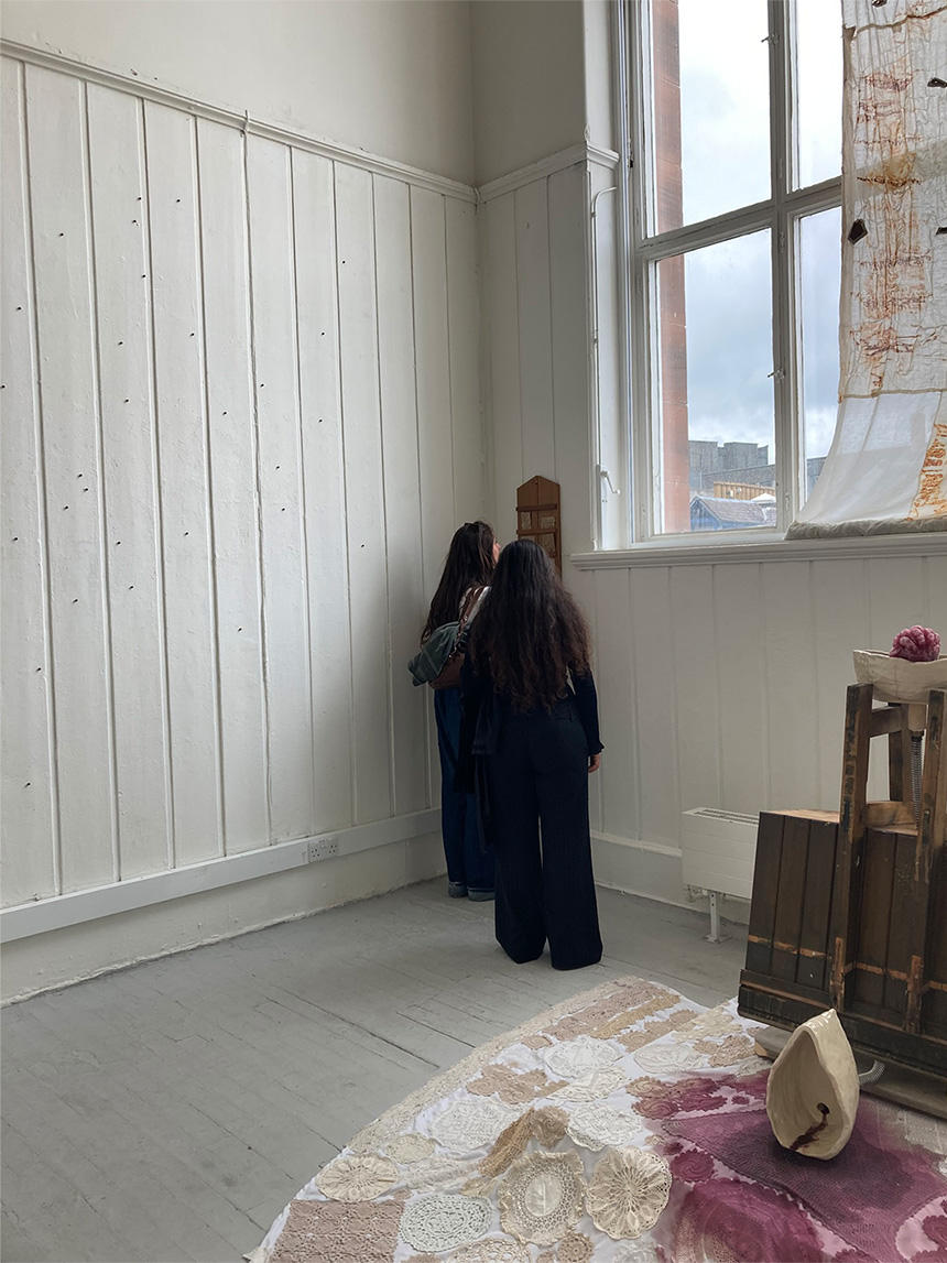 Image of two people looking at wooden hymn board.