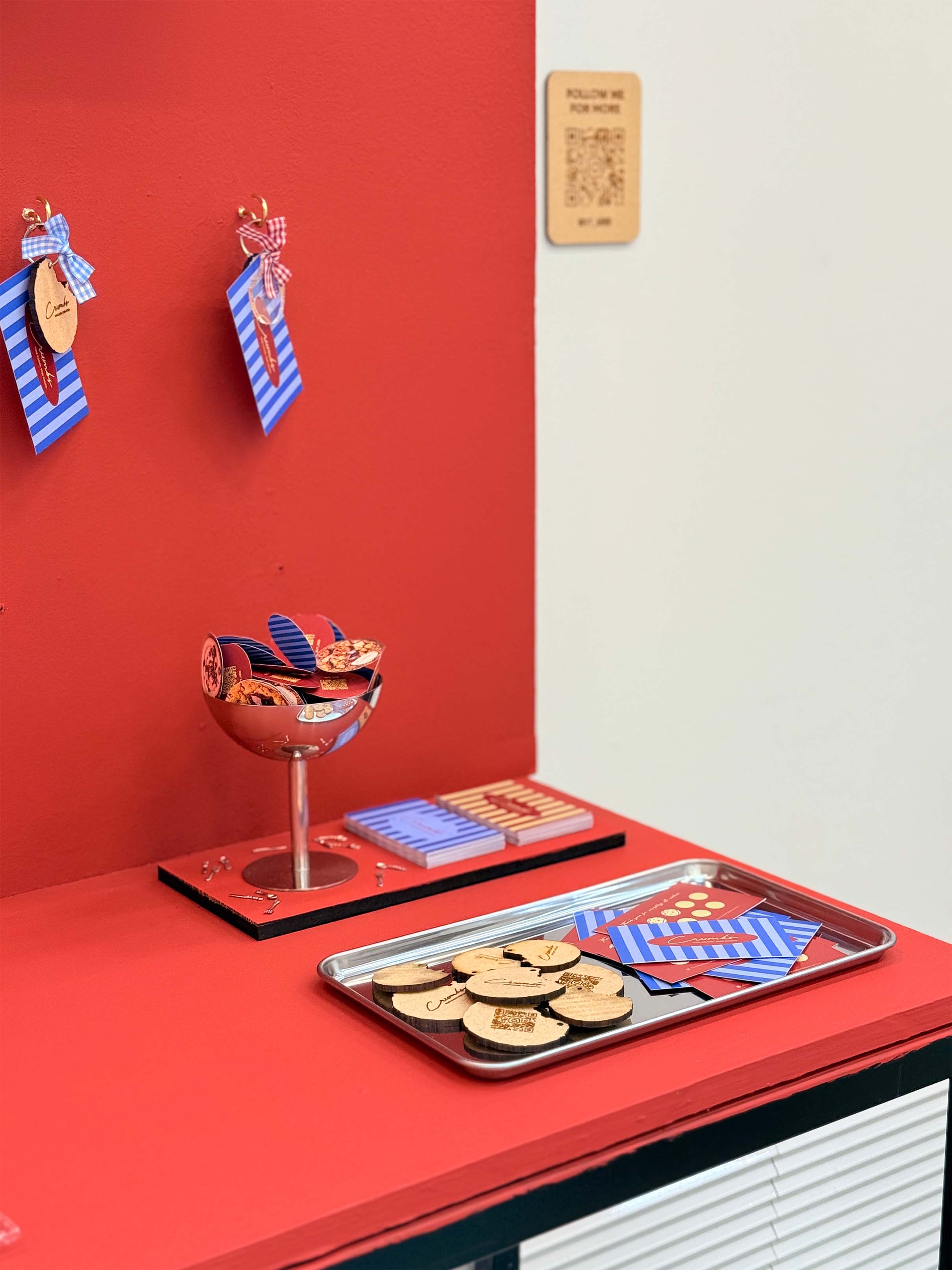 A red display stand featuring brand materials.