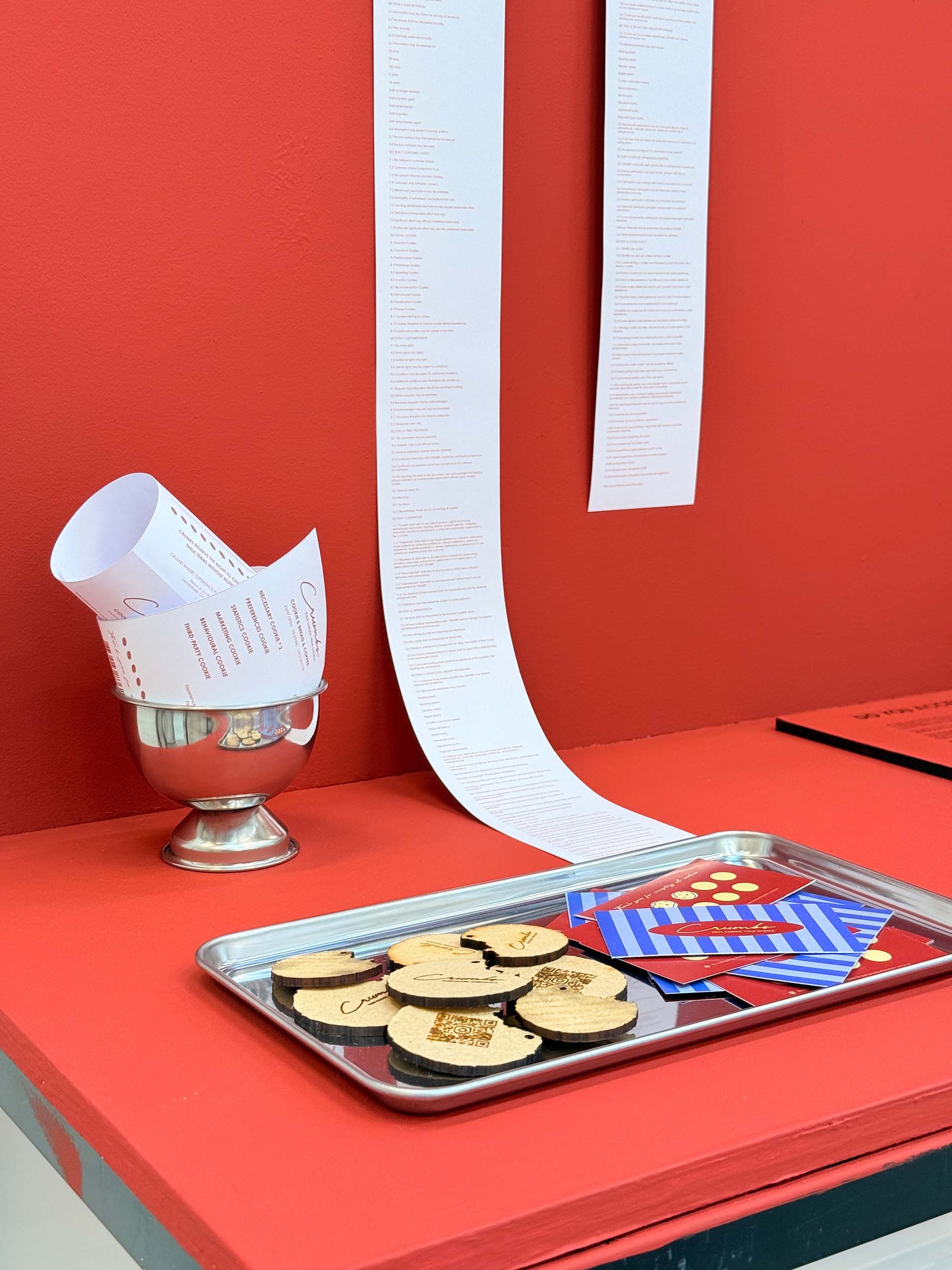 A red display stand featuring brand materials.