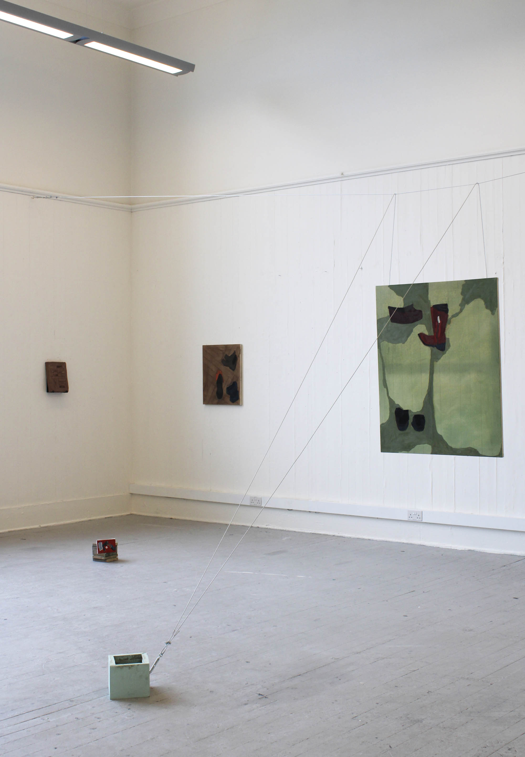 multiple sculptures and paintings in a corner of a room