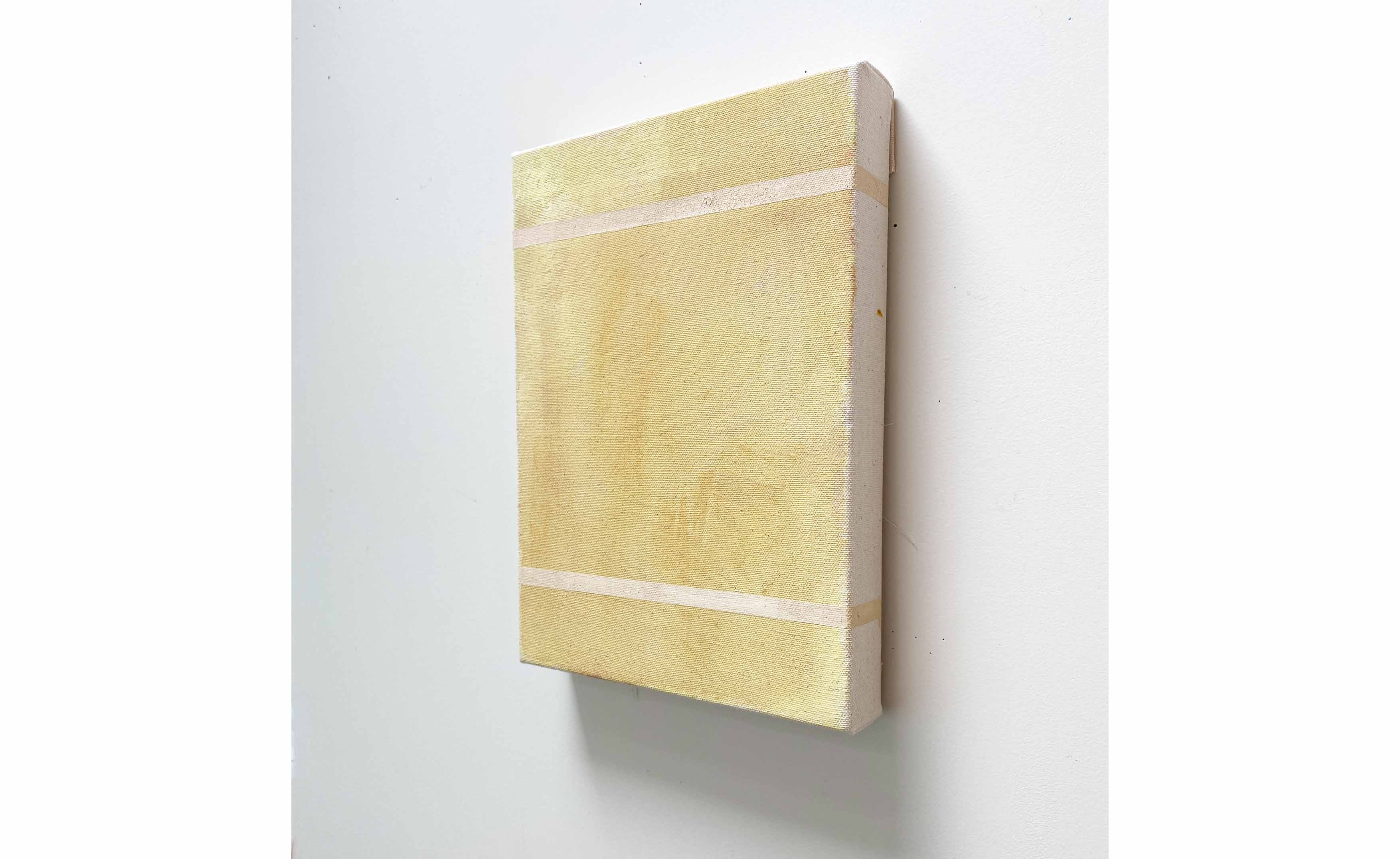 yellow canvas painting displayed on wall