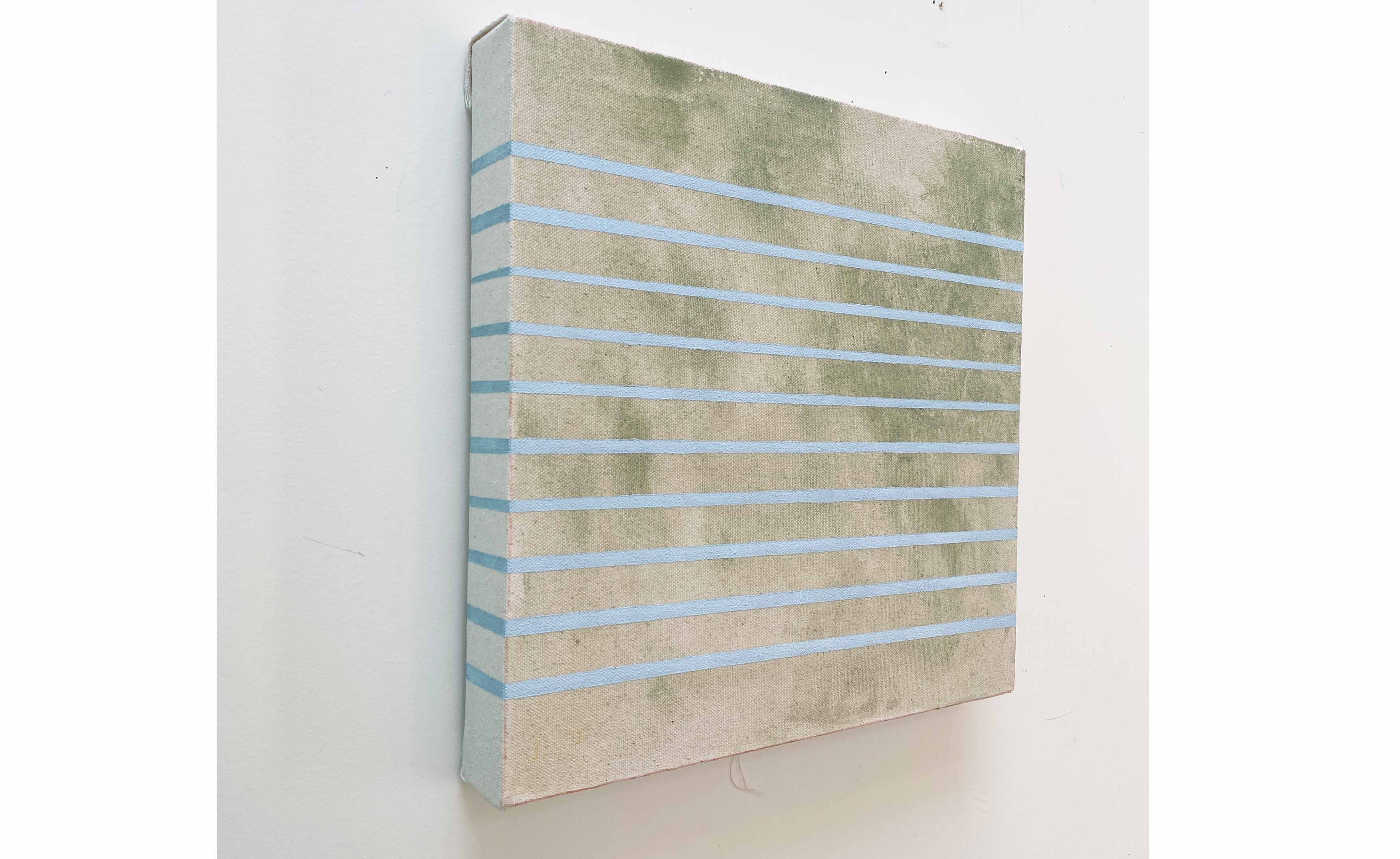 green square painting with pale blue stripes displayed on wall