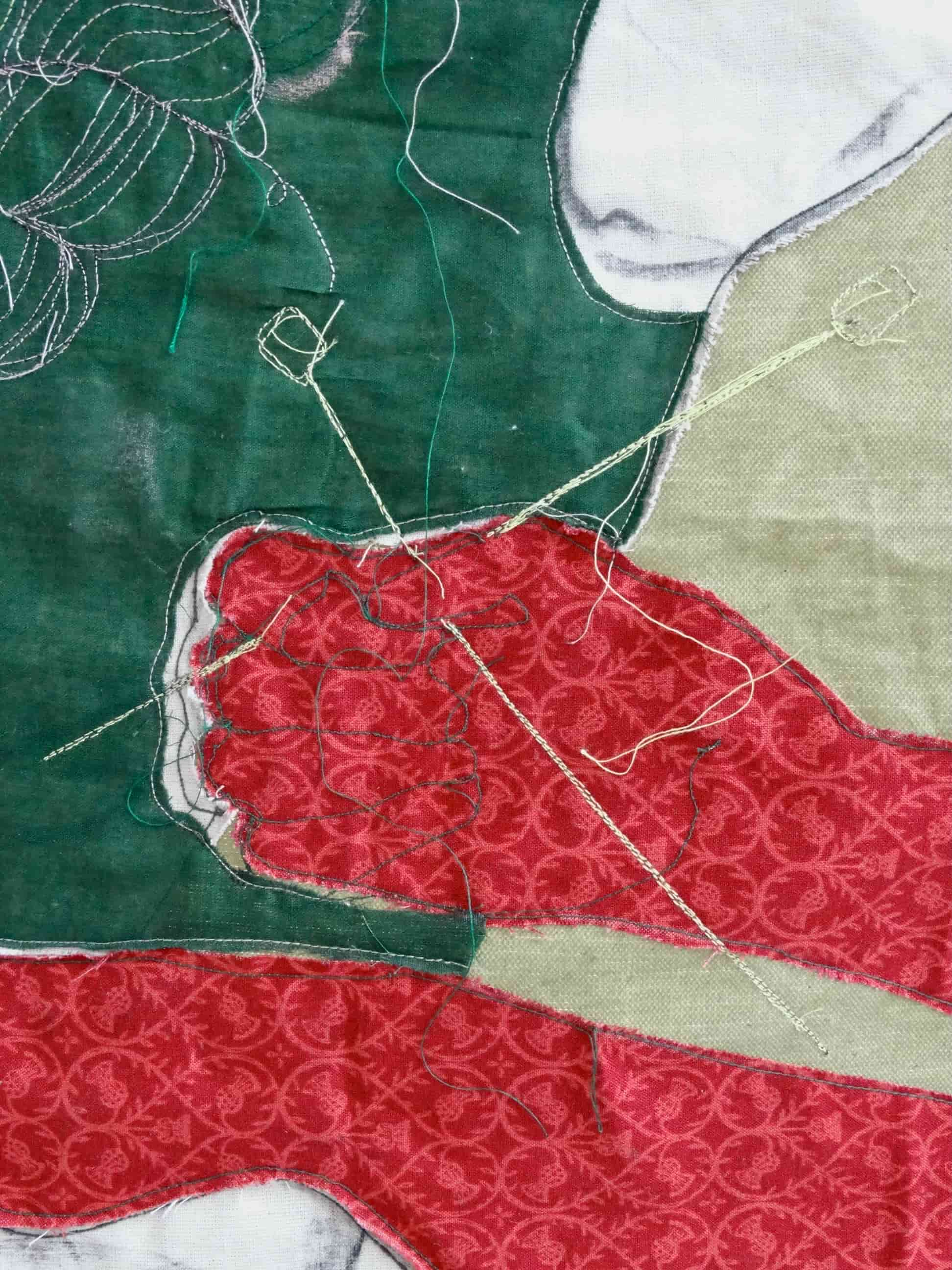 Section of fabric piece ‘Red Gloves’ showing a woman’s hands holding Knitting needles.
