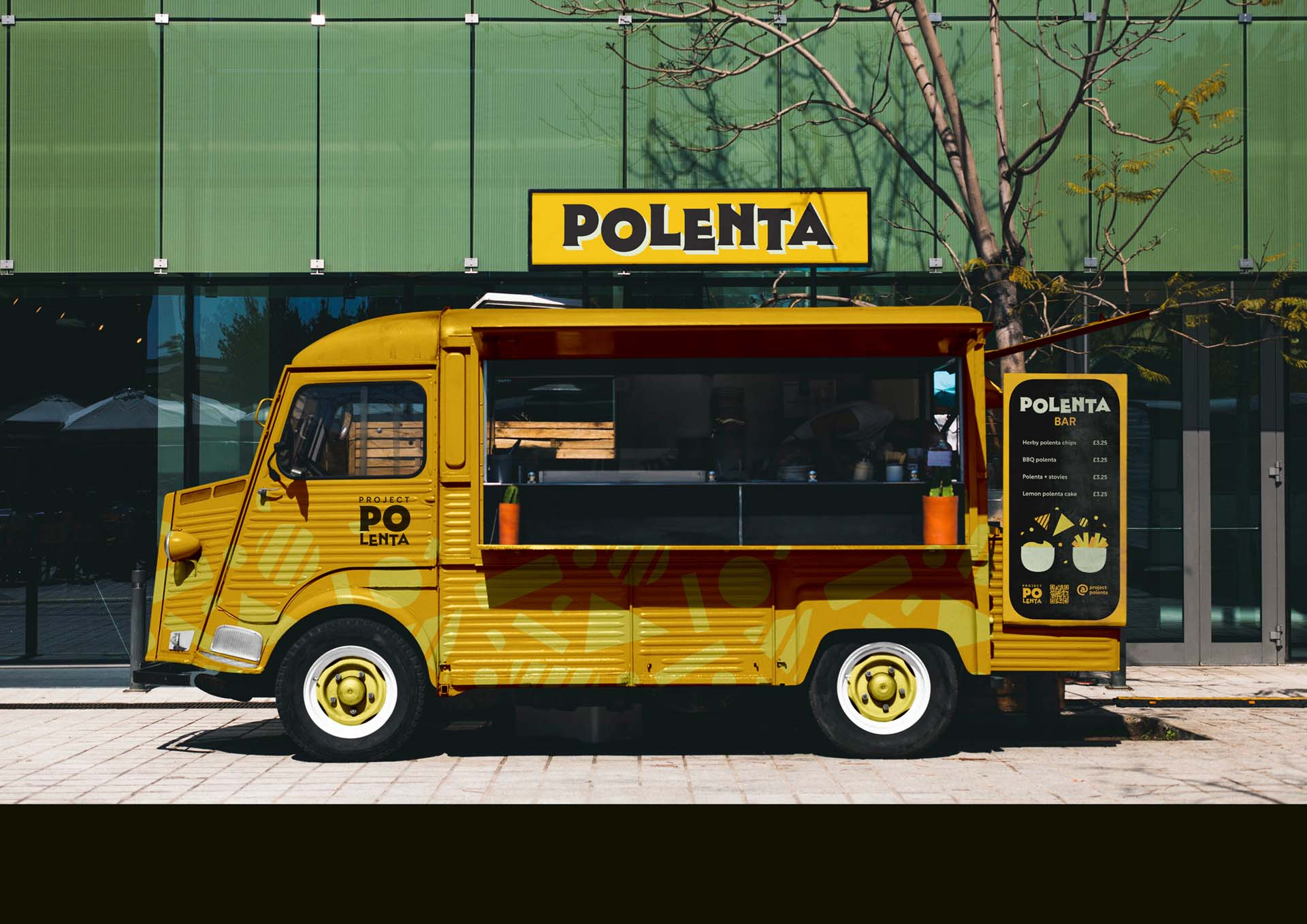 Yellow food truck with polenta sign above in bold vintage font.