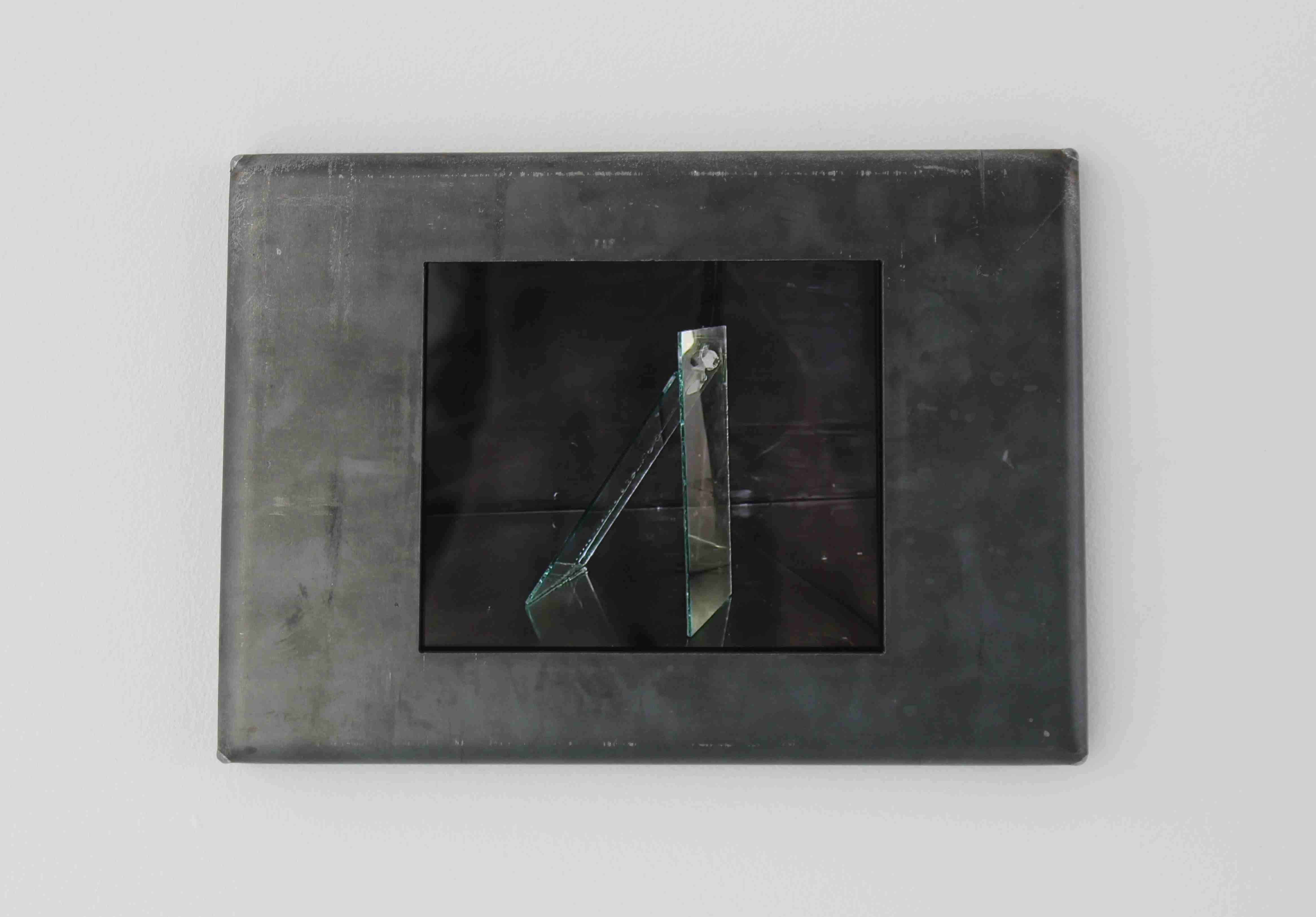 Screen showing an image of two planes of glass being held together by a bolt made of ice.