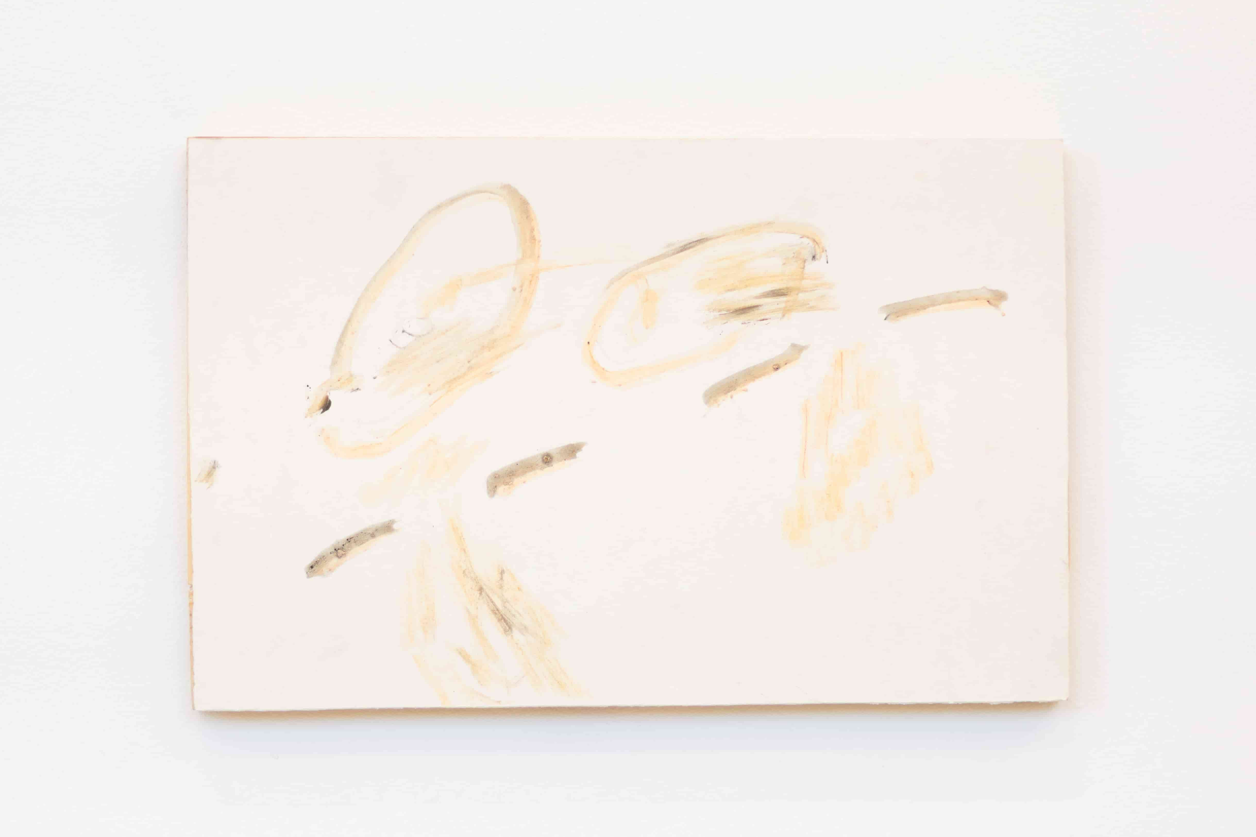 A golden abstract painting on white paper, mounted on wood