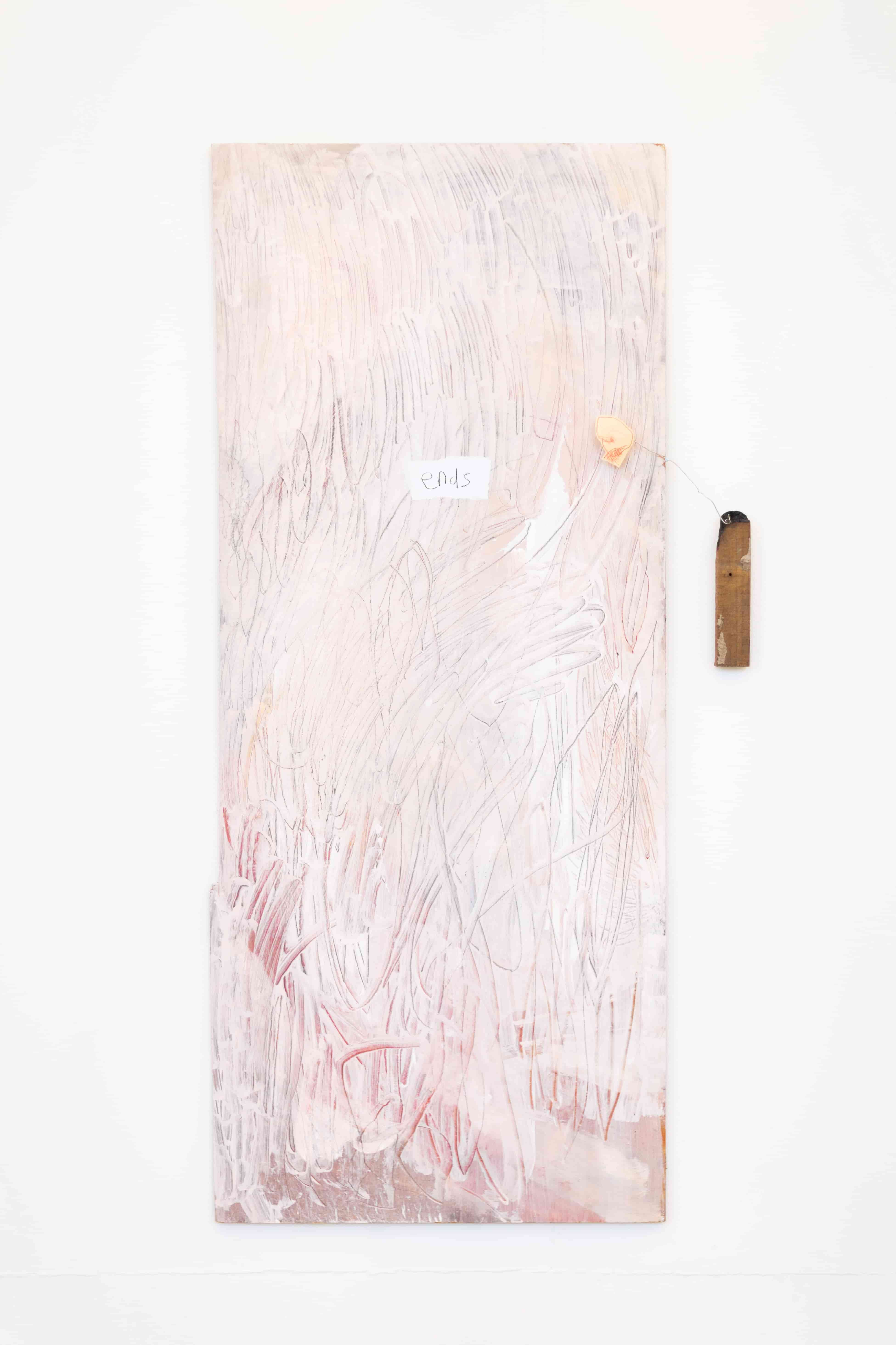 Pink painting on wood with small sculptural figurative element to the side. The text in the middle of the painting reads 'ends'