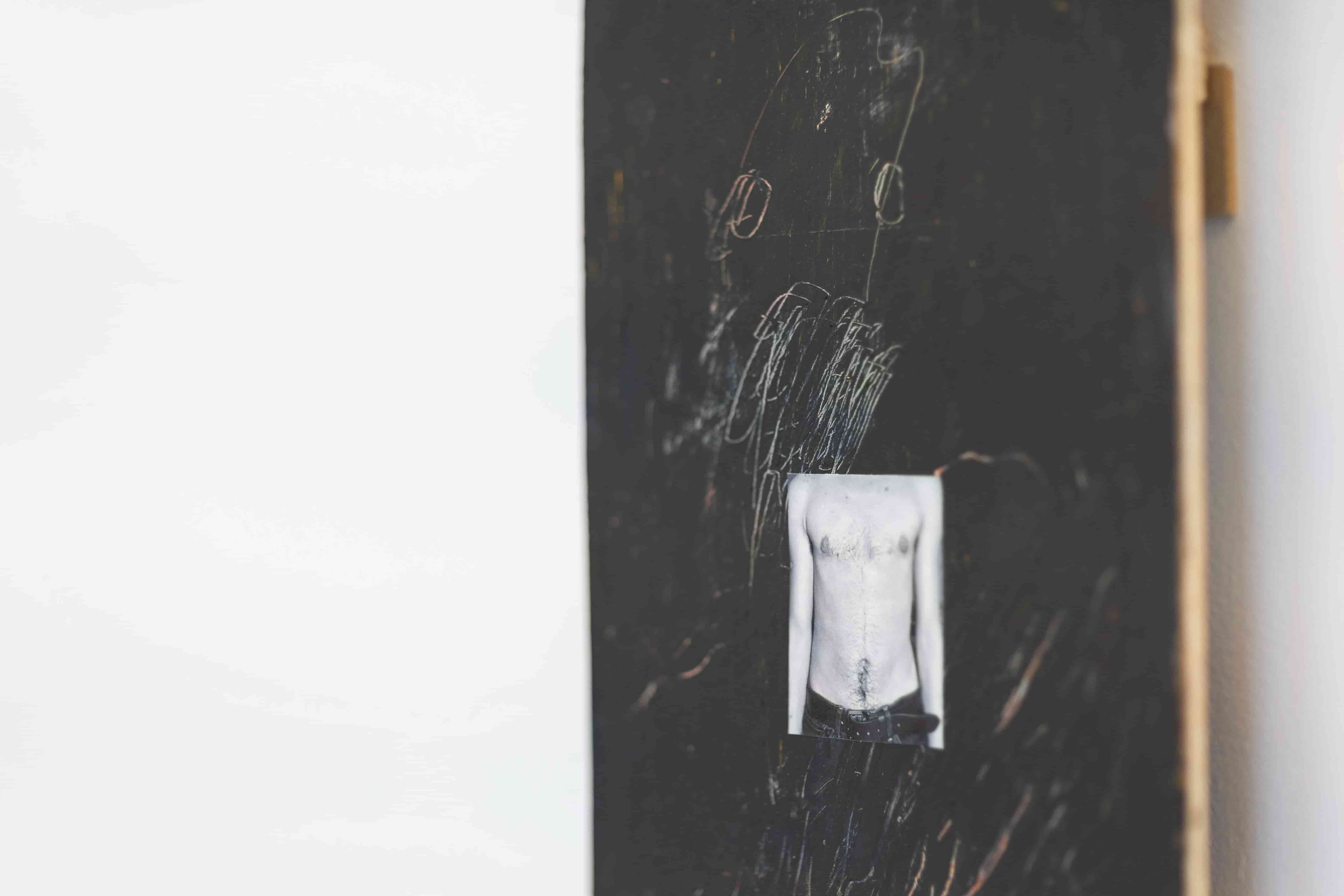 Close up of a dark painting with a photograph on 