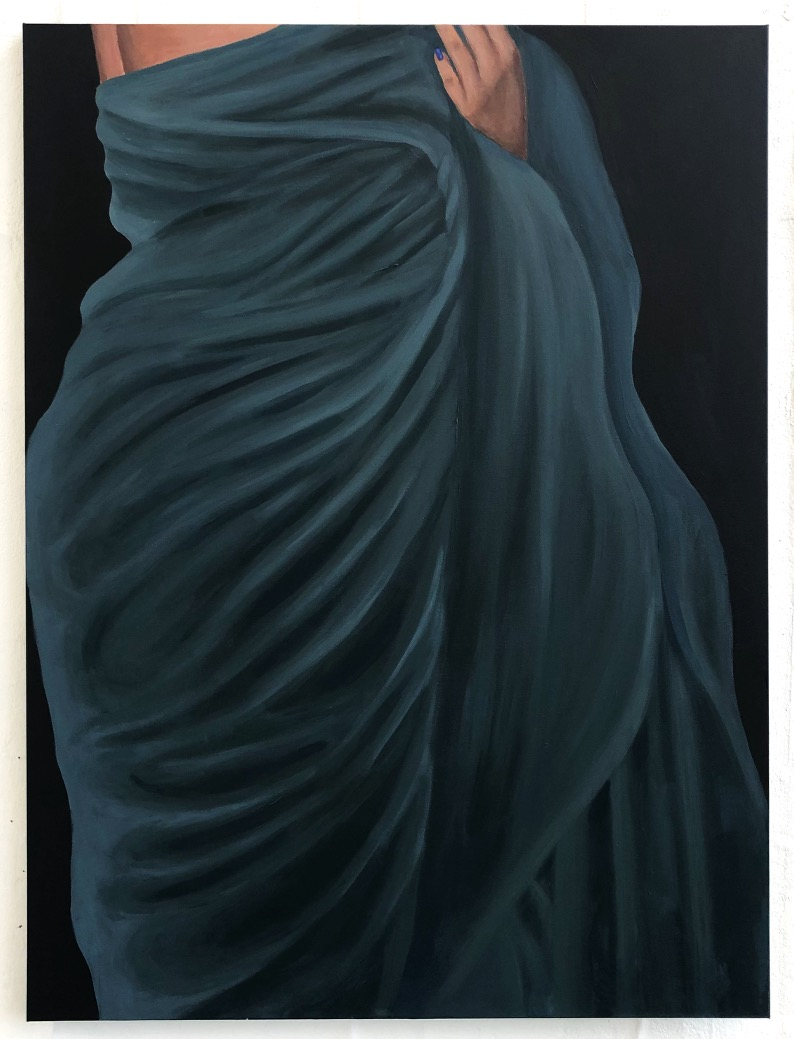 Person wearing teal bedsheet draped around them