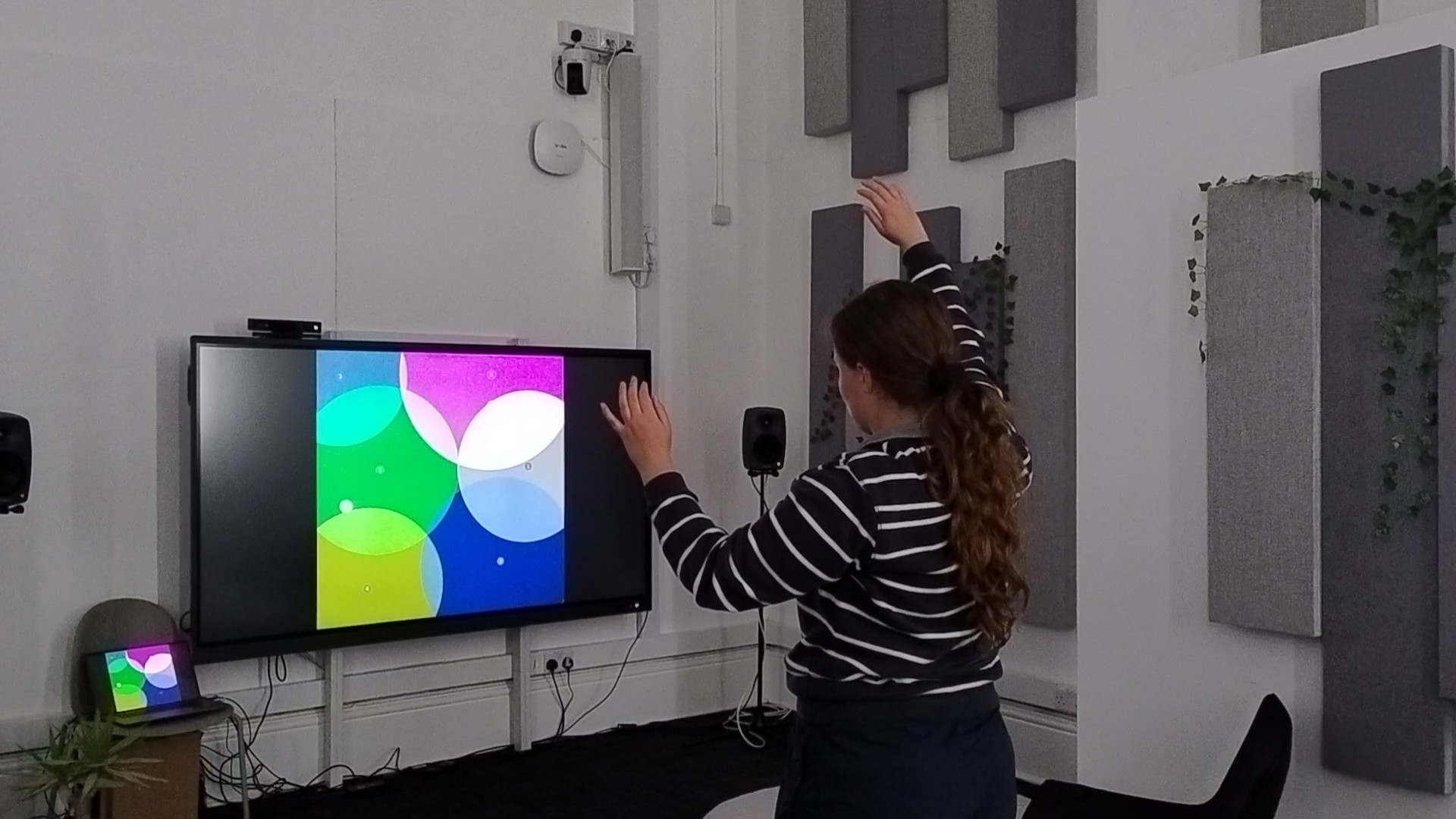 A person moving their hands to interact with the sound installation