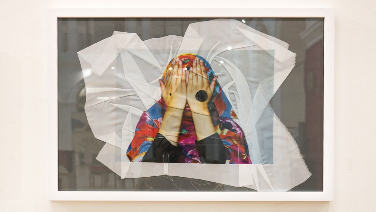 Close up of a frame with white fabric in it.
