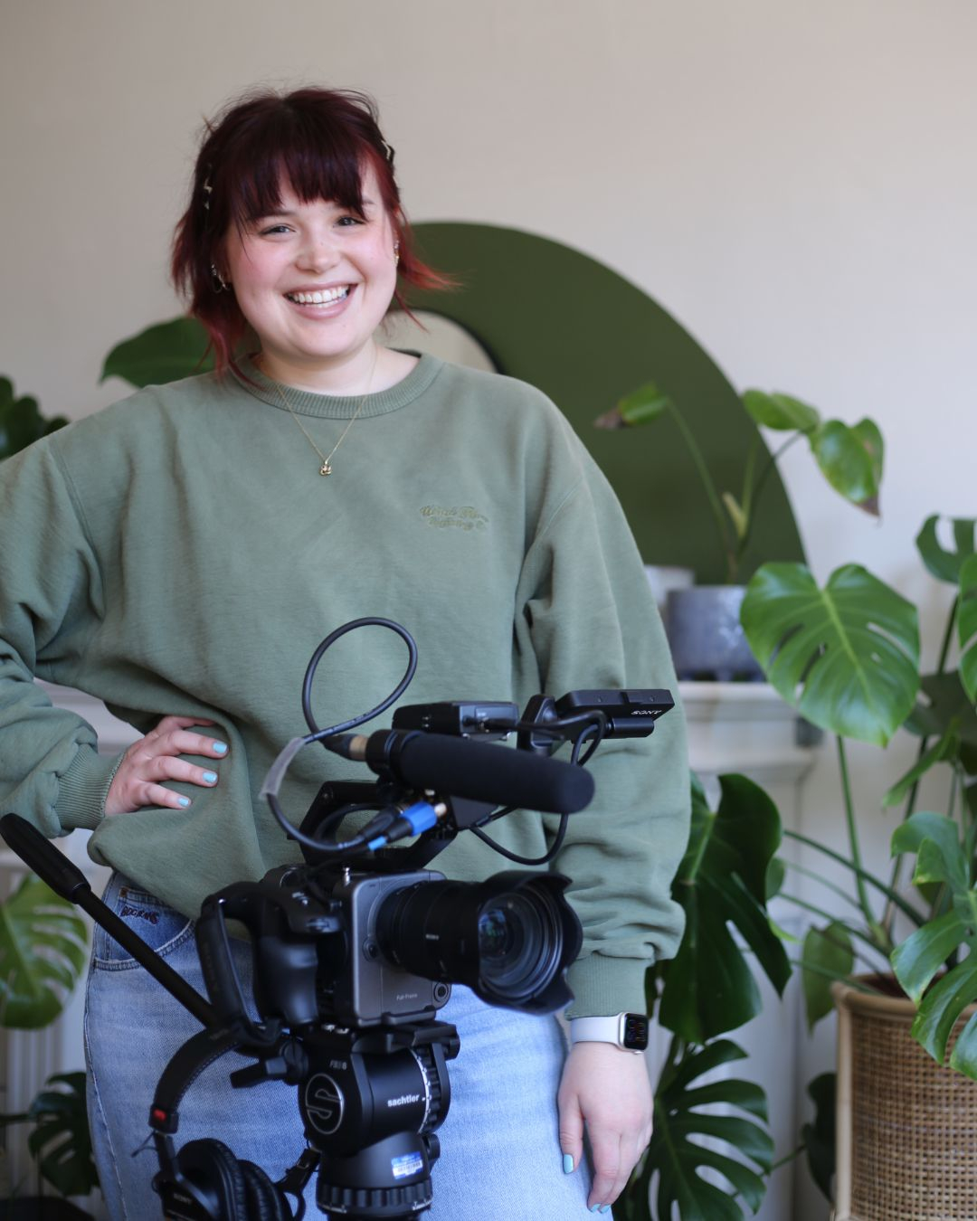 Photo of me standing with my camera on a filming day