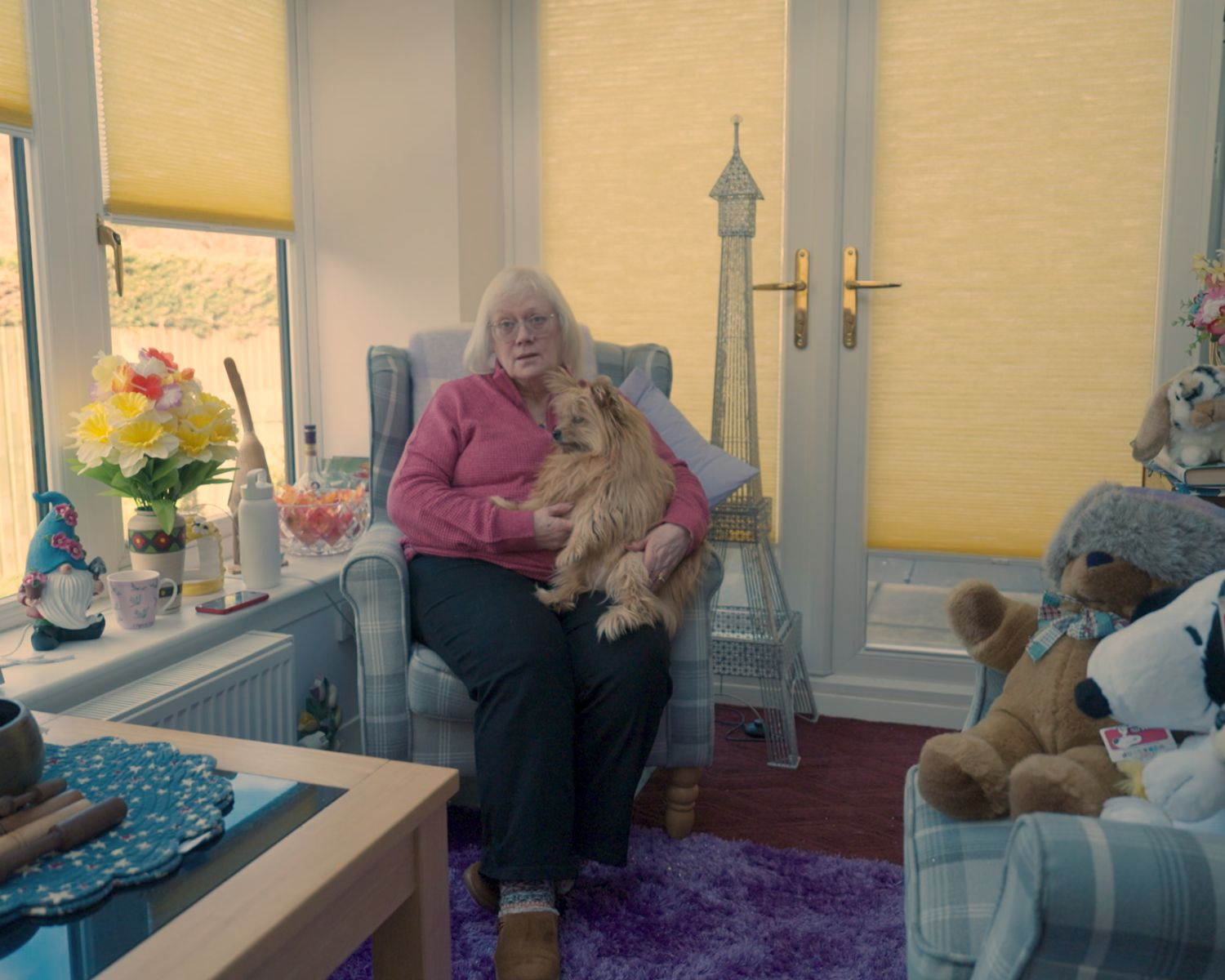 Still from the film of my contributor holding her dog in her home