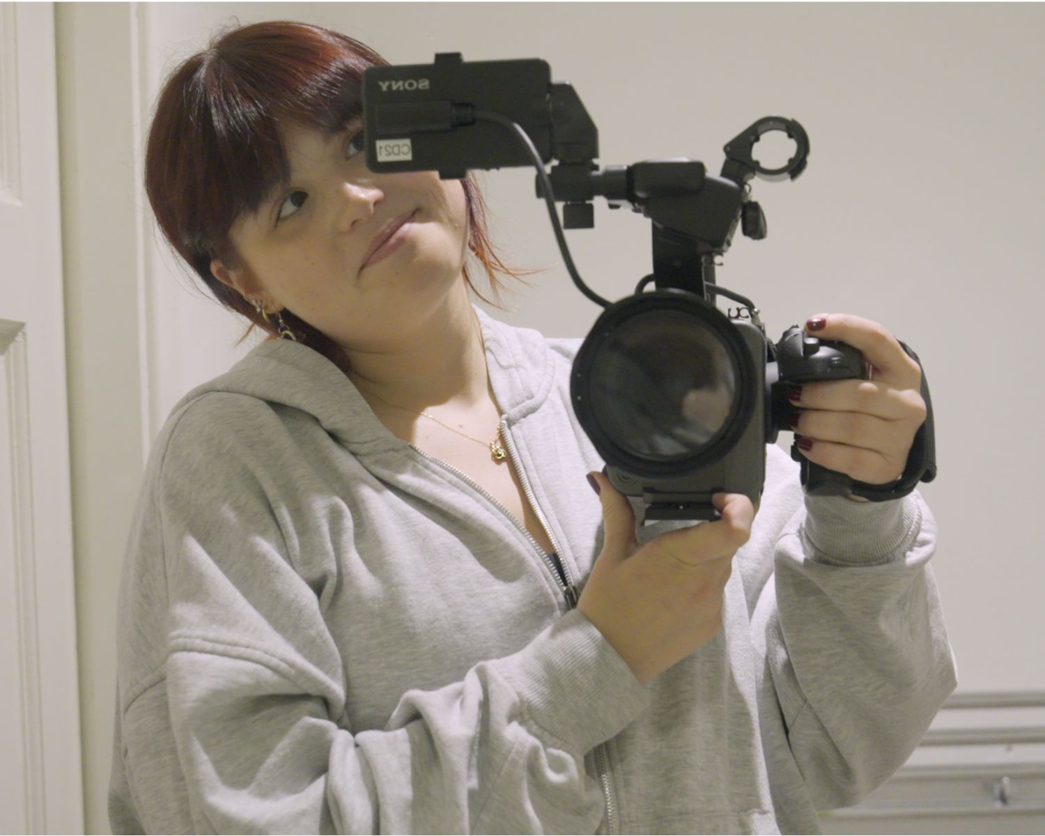 Me filming in the mirror while holding a camera 