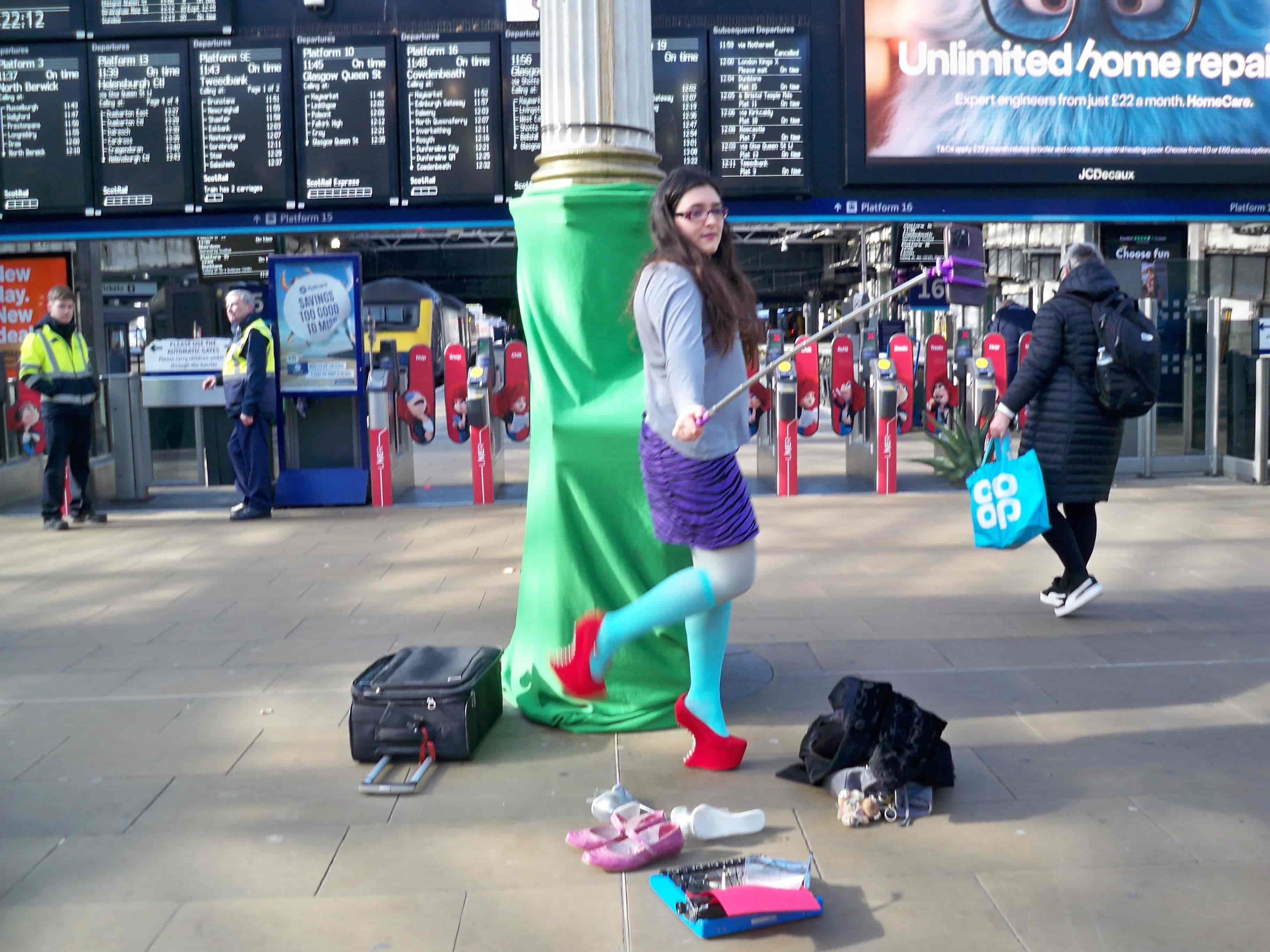 Baddie at the Train Station with Red High heels and taking a video with a very long selfie stick, the security is staring at her