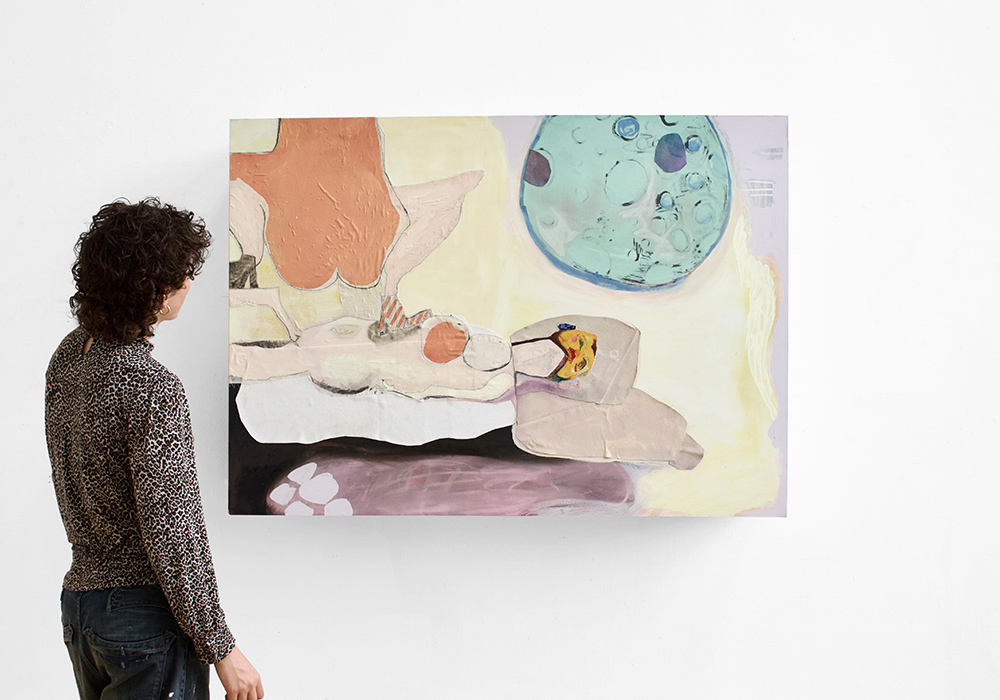 Person stood in front of a painting of 2 people and the moon 