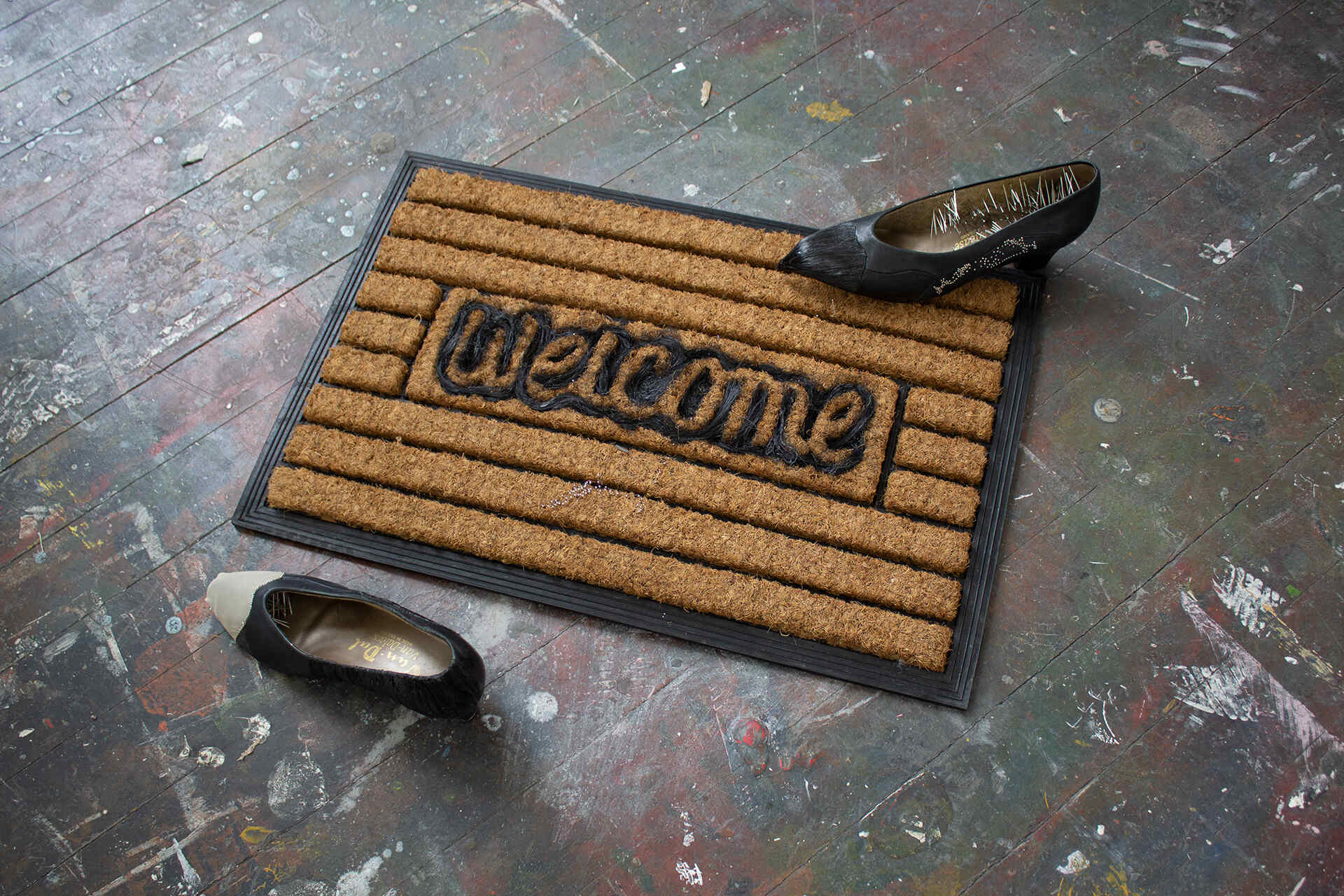 Comfy Cosy, 2026 Sculptural Installation.  Pins, Hair, Chiffon, Leather Shoes, Welcome Mat 50 x 40 cm 
