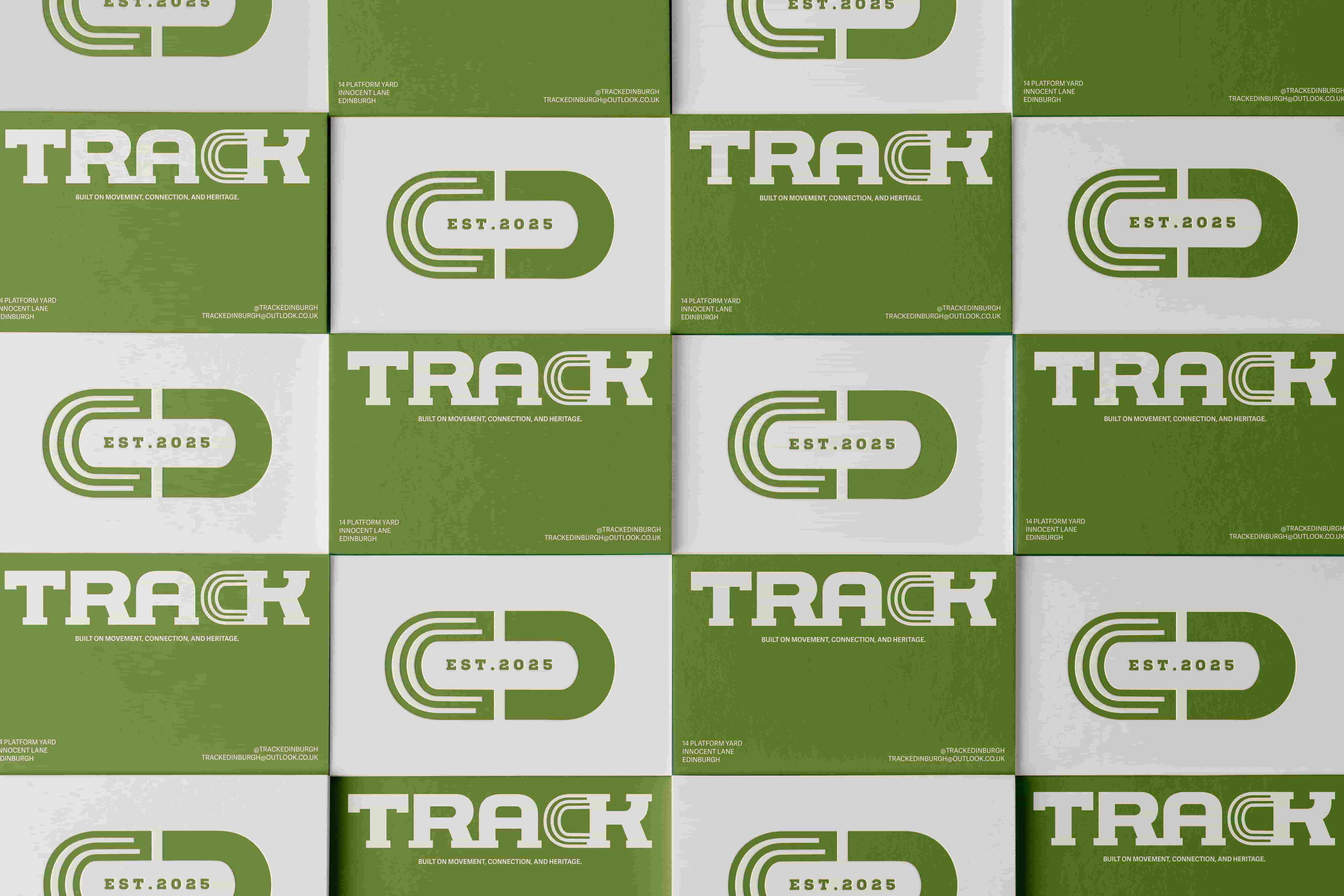     Repeating set of TRACK branded business cards arranged in a grid pattern. The cards use a green and white colour palette with the TRACK logo, railway inspired symbol mark, ‘EST. 2025’ branding, and store contact details.
