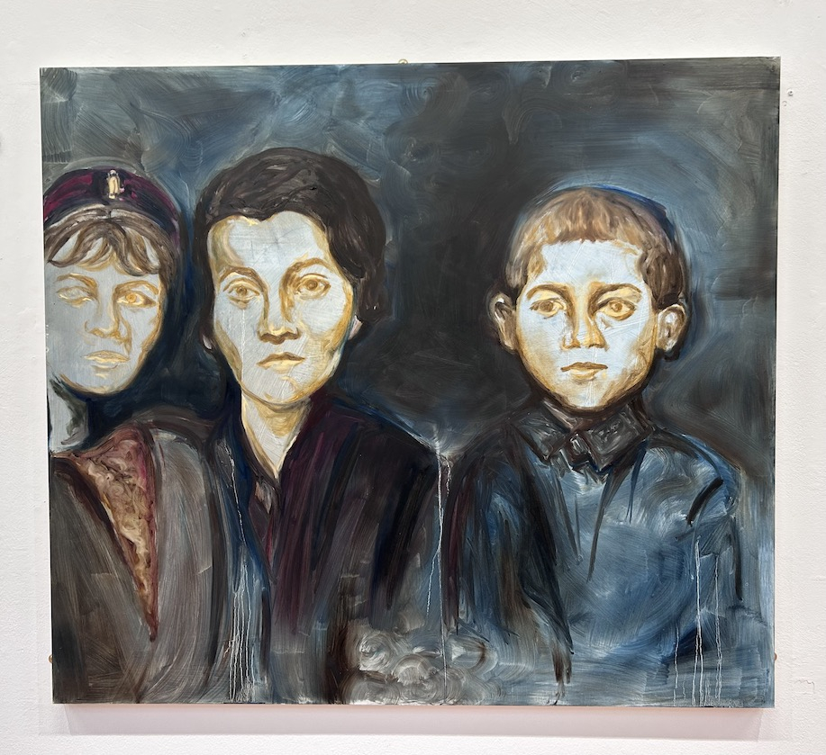 There are three painted figures. On the left side of the work, there is a girl and a woman. On the right side, there is a boy.