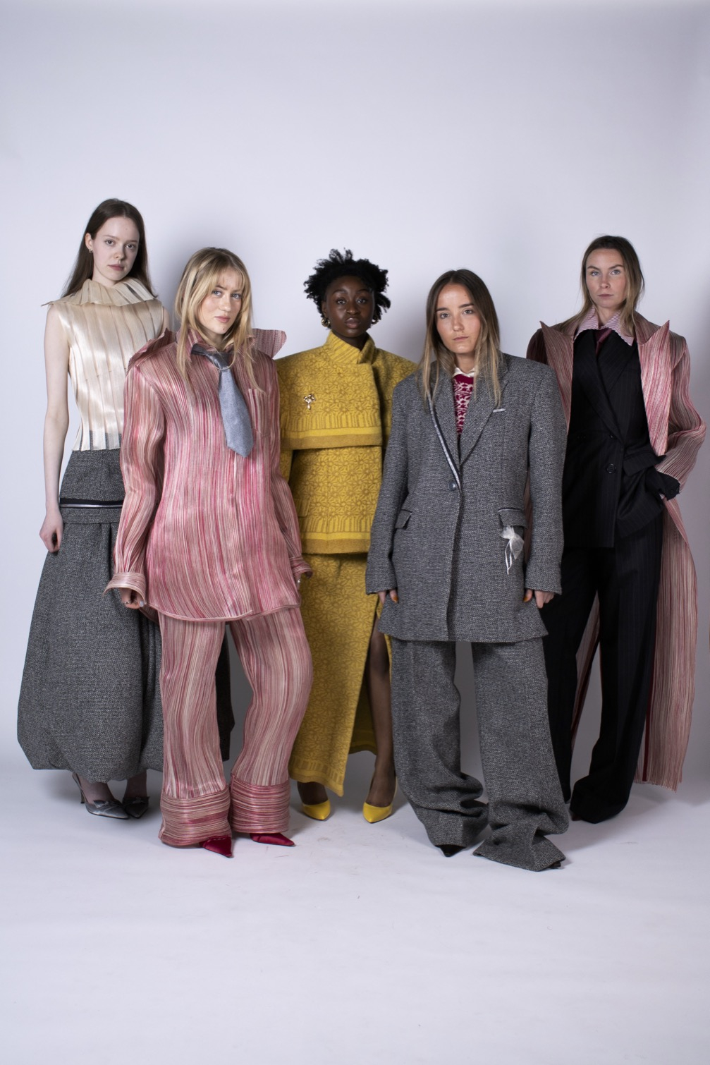 Five women wearing tailoring collection, including suits, knitted and silk abaca garments