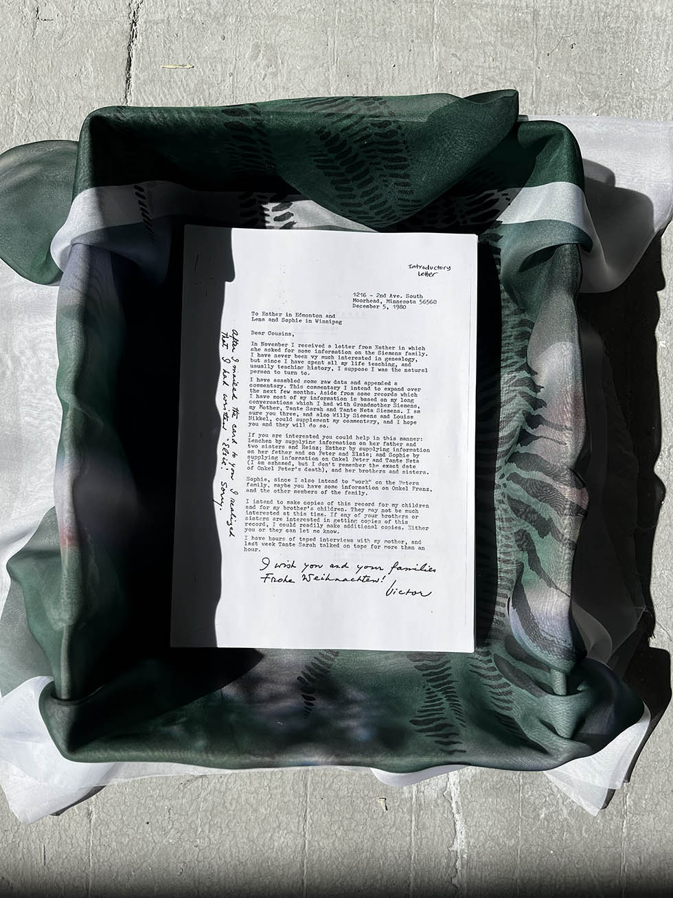 Photograph of archival material in lined archive box.