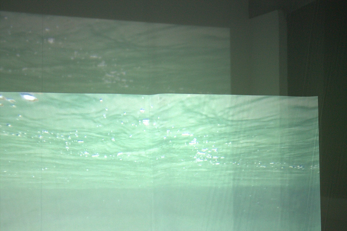 Film projection of water onto transparent fabric.
