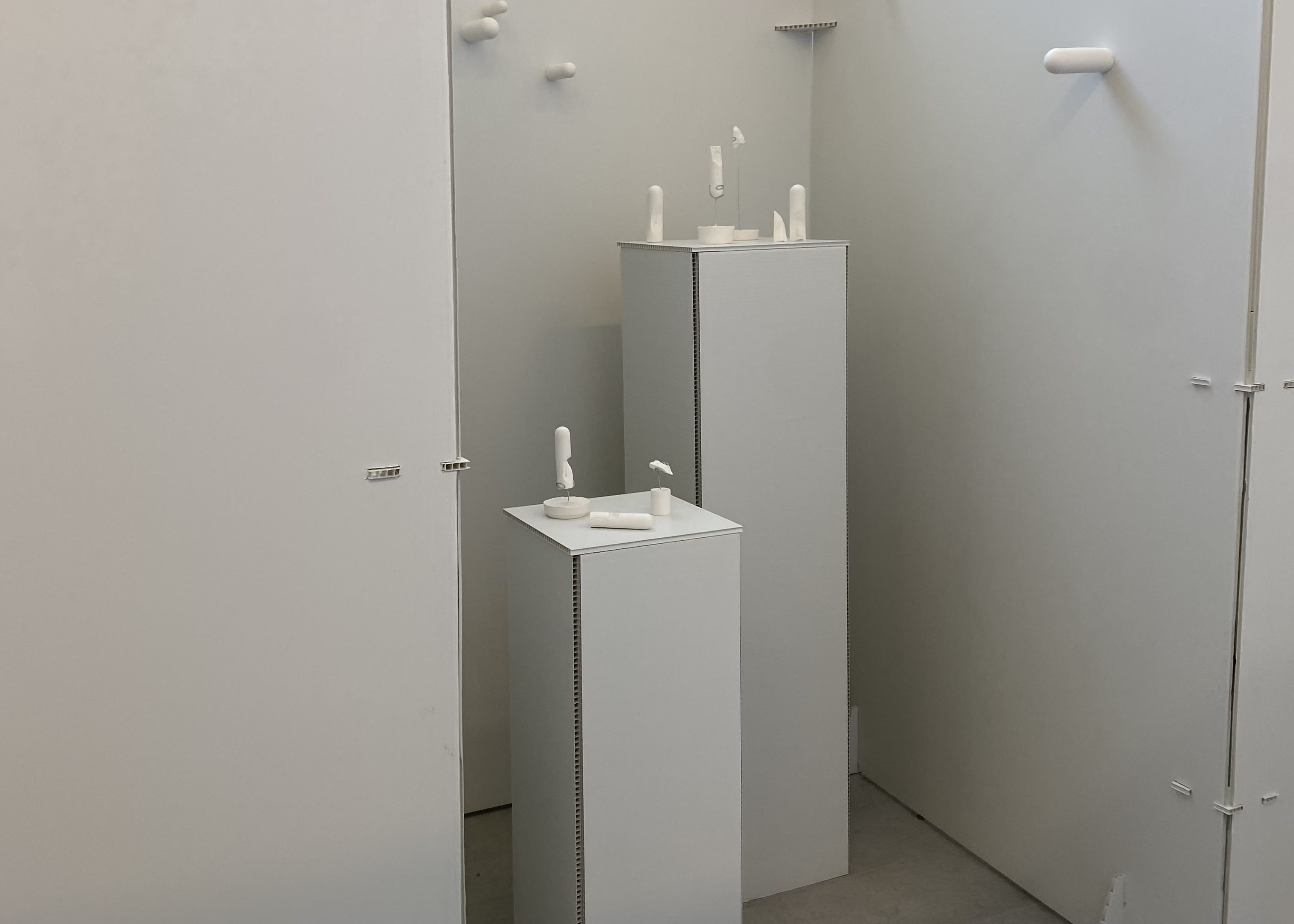 Installation view of broken plaster casts on Correx plinths.