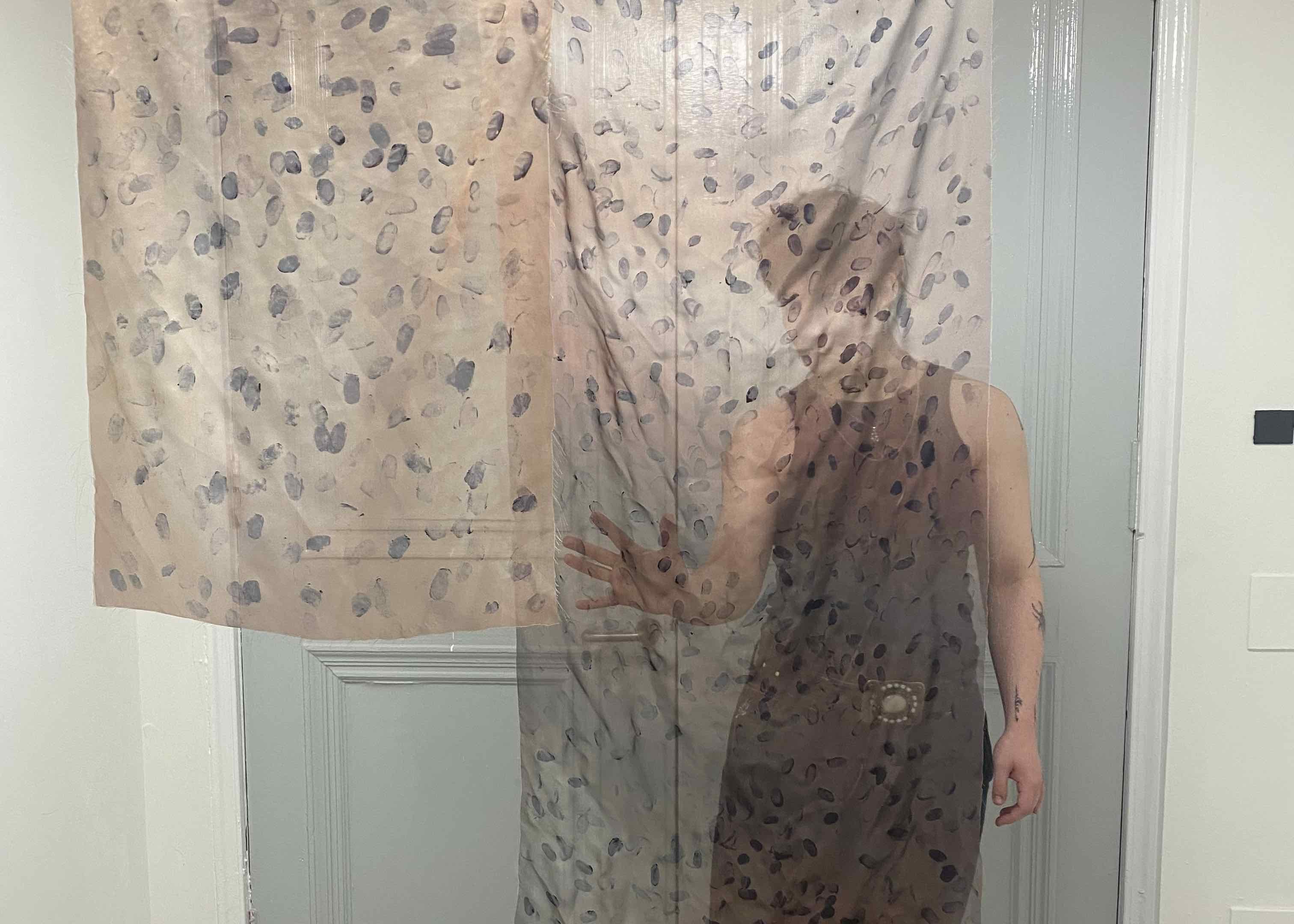 Translucent fabric hung in gallery space.