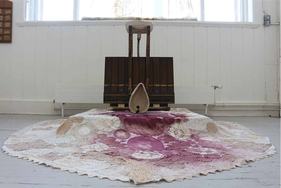 Image of sculpture made from ceramic, wood, metal piping, and textiles.