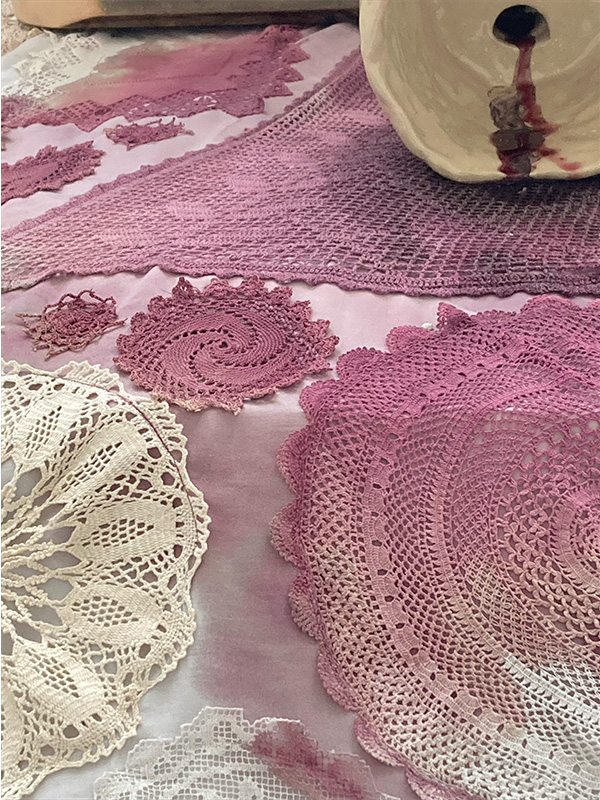 Image of crochet rug stained with red wine.