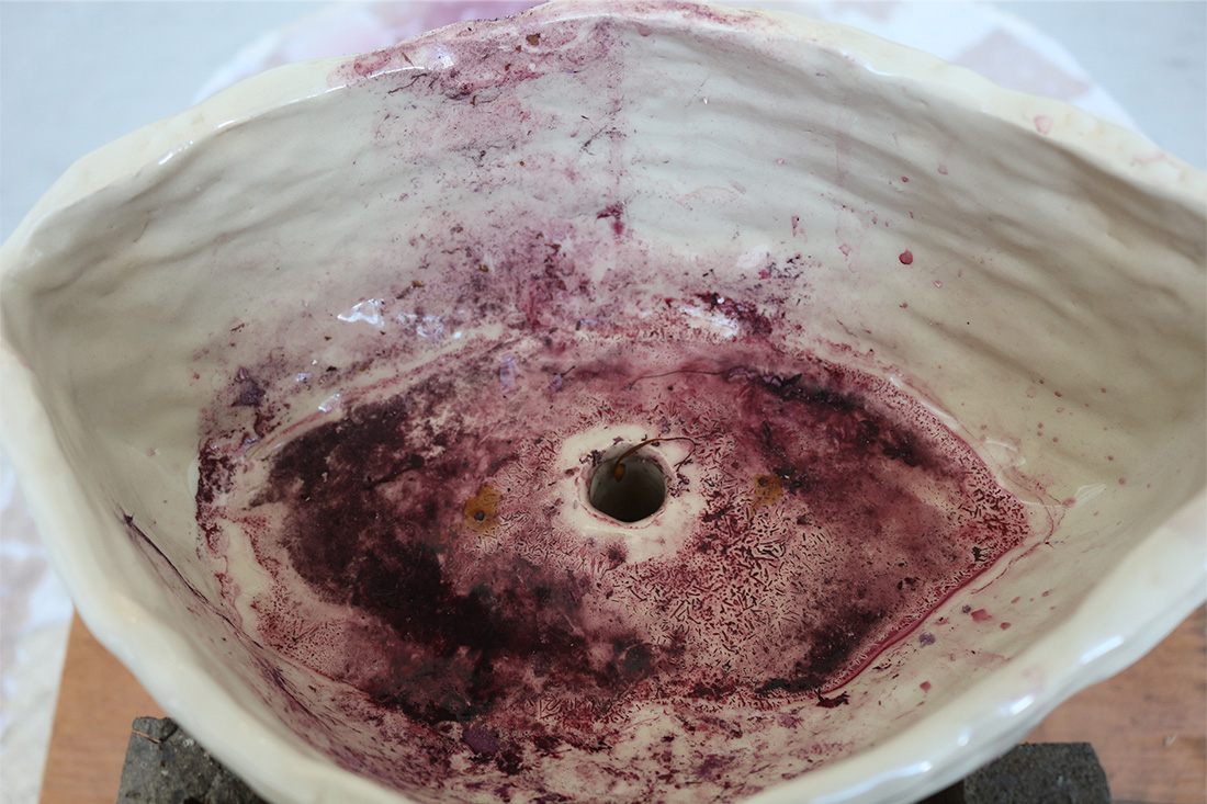 Image of ceramic sculpture stained with red wine.