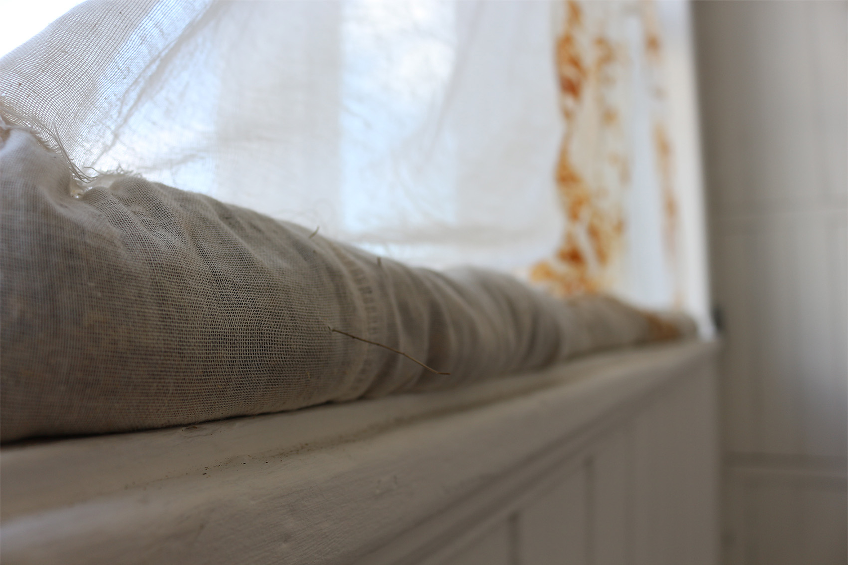 Image of rust dyed cotton textile filled with herbs.